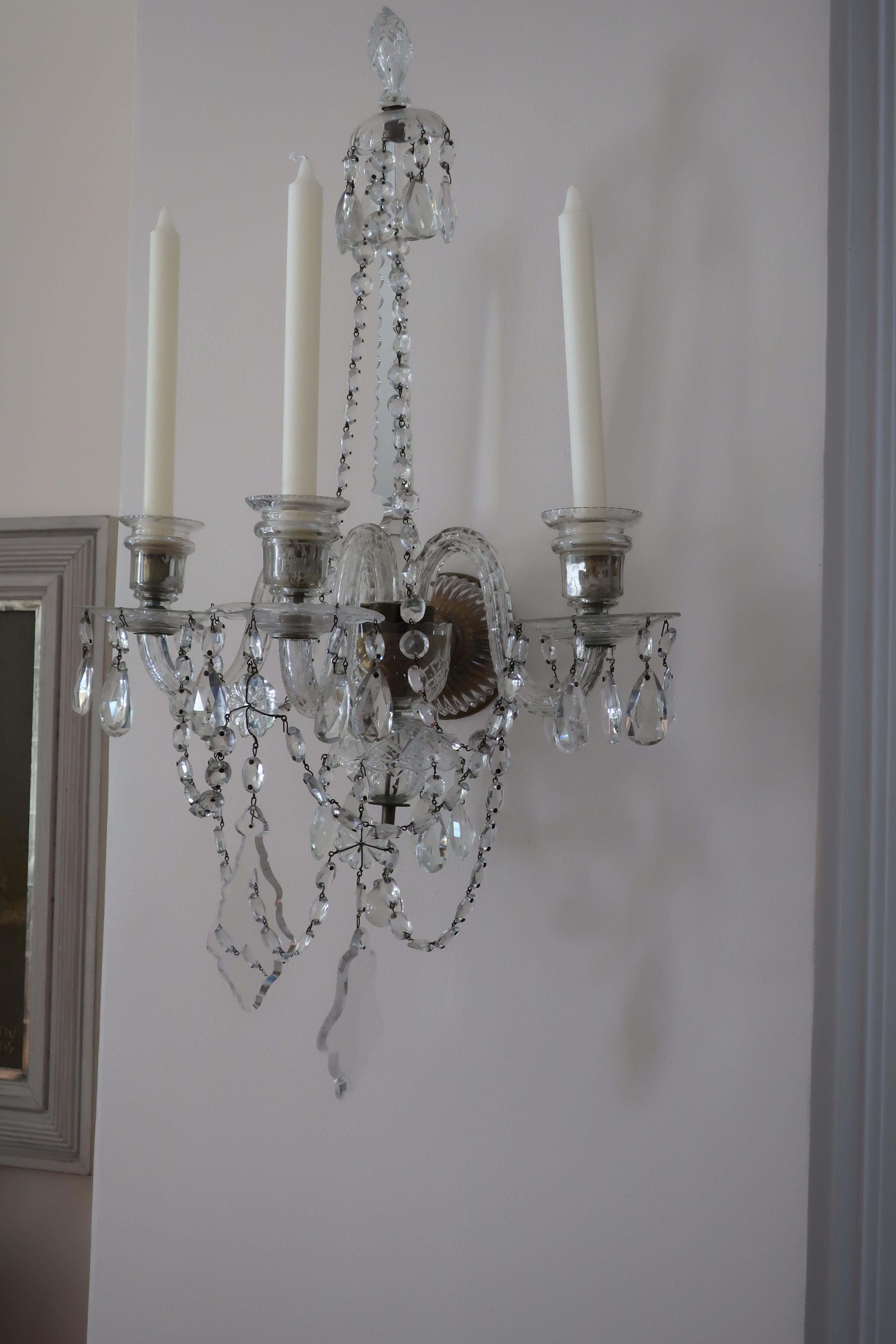 Pair of baccarat style three-arm crystal wall sconces
A stunning and large scale pair of French 19th century Louis XVI style Baccarat cut-lead crystal three-arm sconces. Each sconce is topped by a beautiful glass obelisk mirrored spire. The three