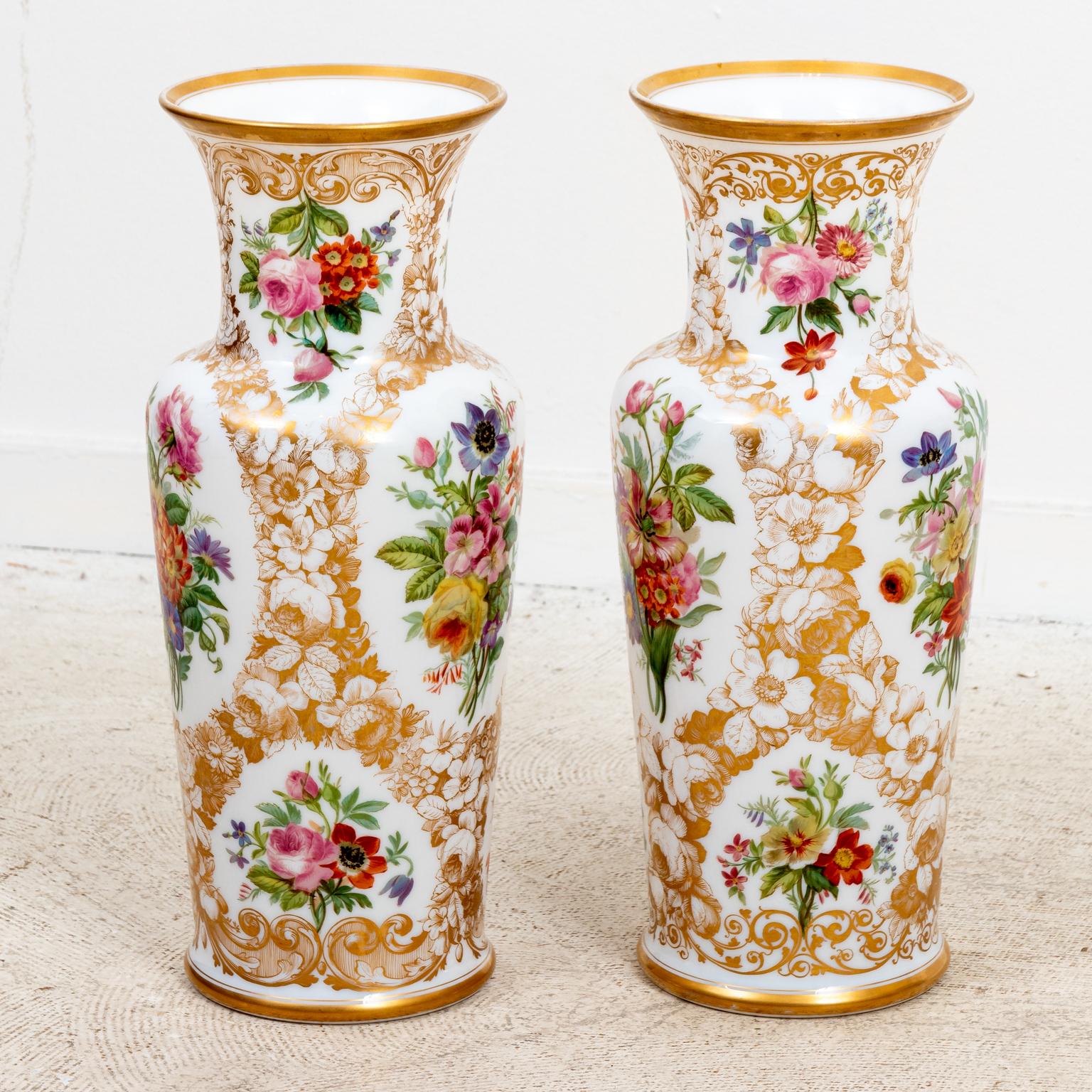 Circa 1825-1850s pair of white opaline Baccarat glass floral painted vases painted by Jean Francois Robert. Label on bottom. Purchased in early 1960s for $2000. Made in France. Please note of wear consistent with age. Gold leaf in excellent