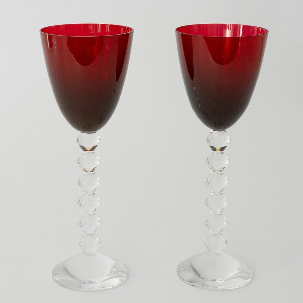 Heading :  Pair of Baccarat Vega wine glasses with ruby red bowls
Period : Modern
Origin : Baccarat, France
Colour : Ruby red bowls with clear stems and feet
Bowl : Round funnel
Stem : Formed of angular knops not dissimilar to a bobbin stem on a