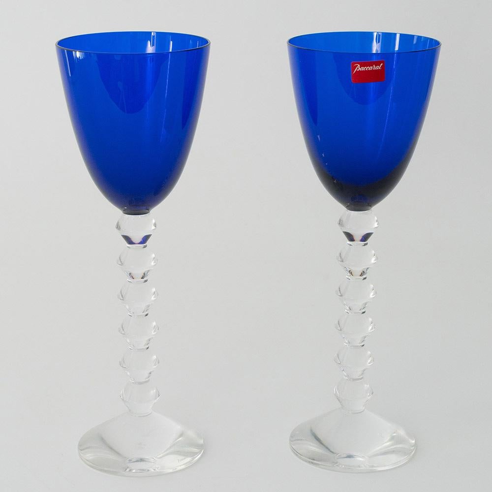 Heading :  Pair of Baccarat Vega wine glasses with sapphire blue bowls
Period : Modern
Origin : Baccarat, France
Colour : Saphire blue bowls with clear stems and feet
Bowl : Round funnel
Stem : Formed of angular knops not dissimilar to a bobbin stem