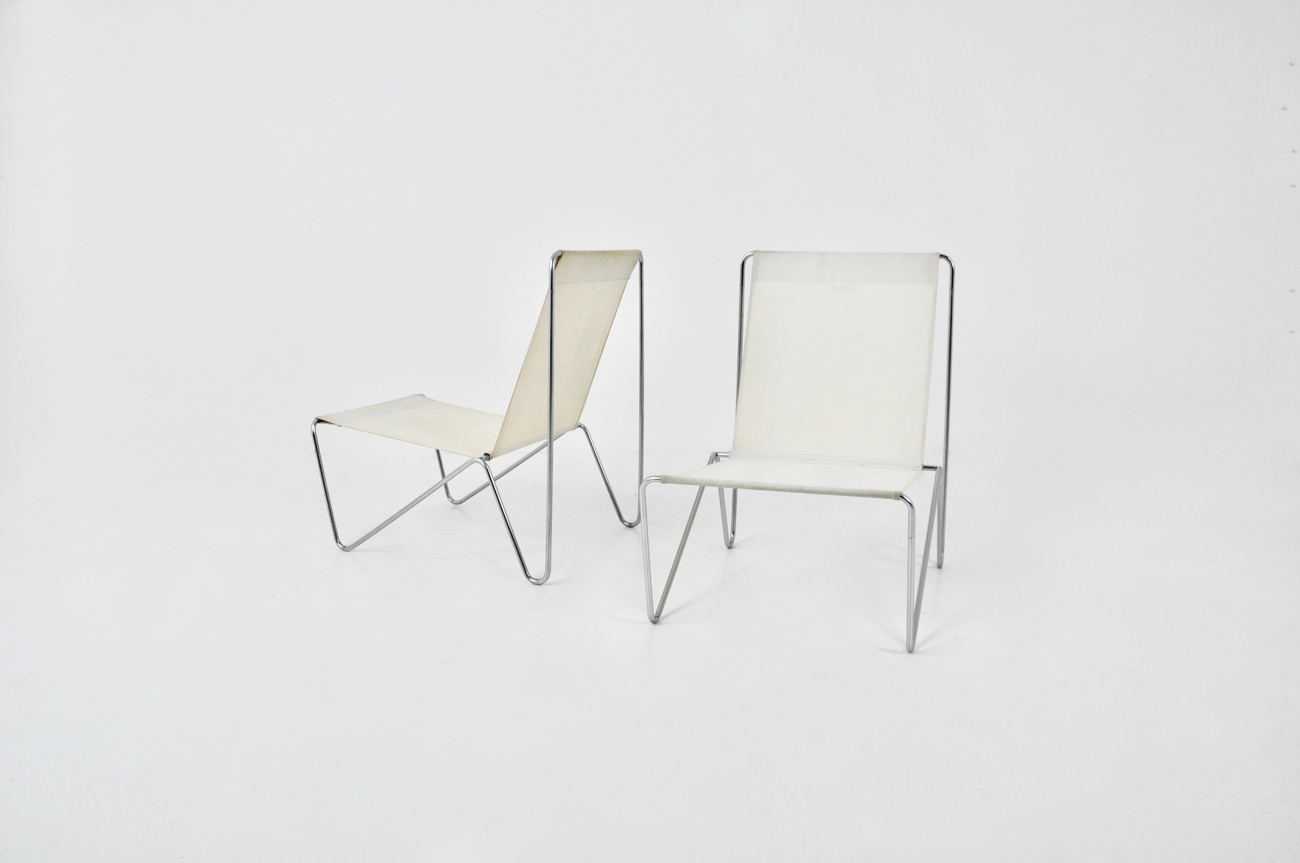 Pair of armchairs in white creame fabric with metal frame. Stamped on the back. Seat height: 33 cm. Wear due to time and age.