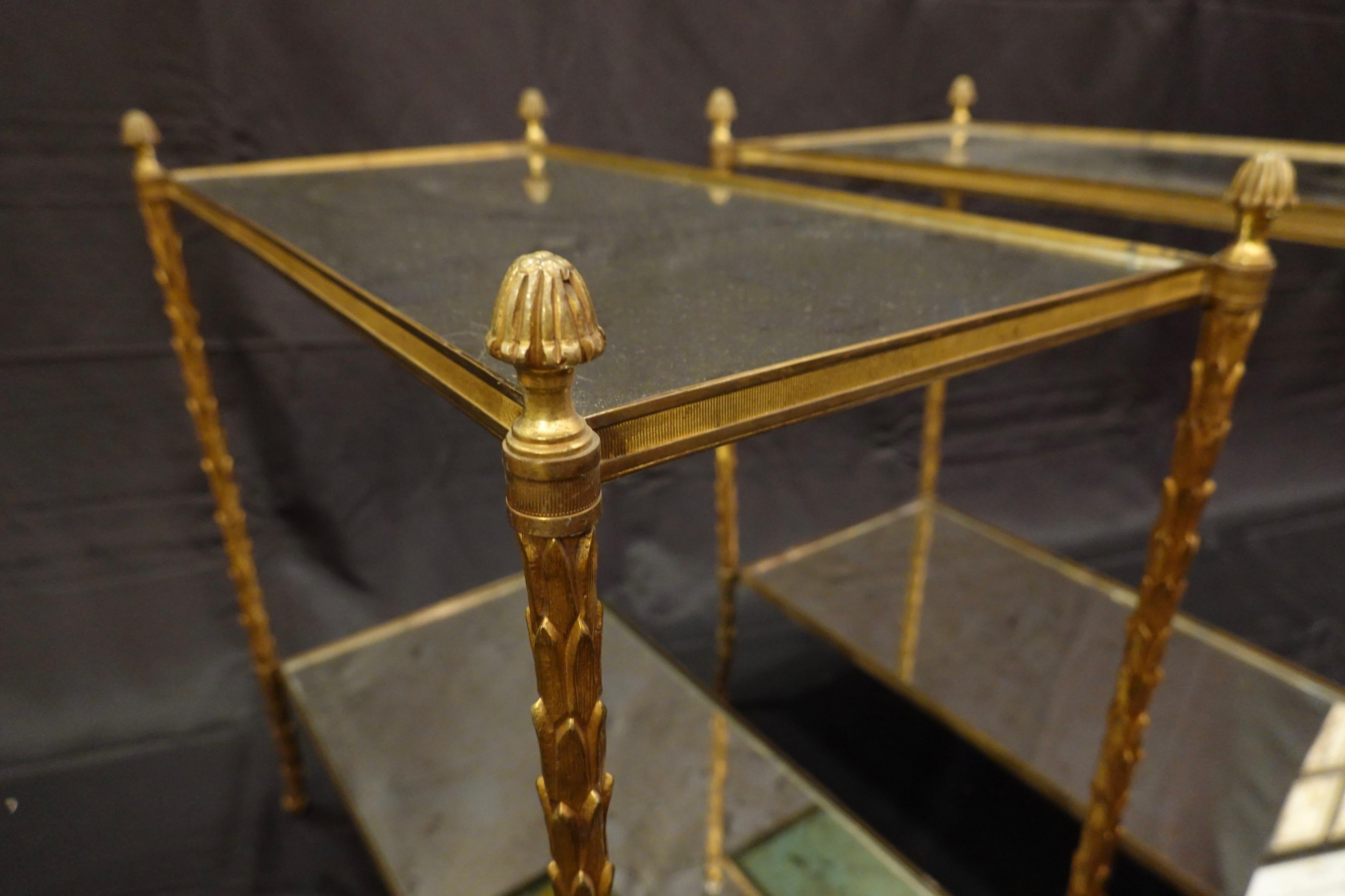 Brass Pair of Bagues Gilt-Bronze Two-Tiered Side Tables with Eglomise Glass Tops For Sale