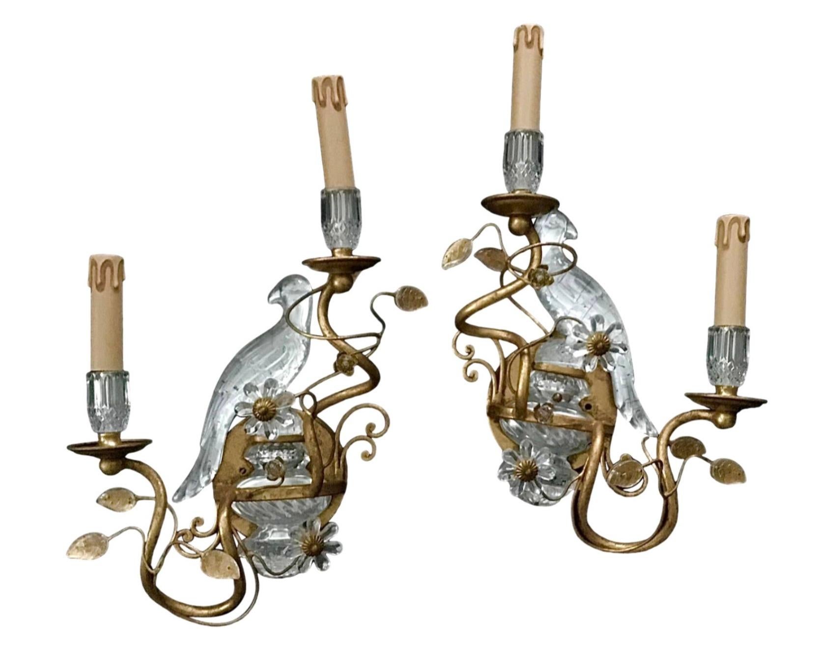 Beautiful French Maison Bagues style electrified sconces with characteristic Parrot Design. This is a pair of gilt and crystal sconces depicting reverse facing birds.
Height overall 19