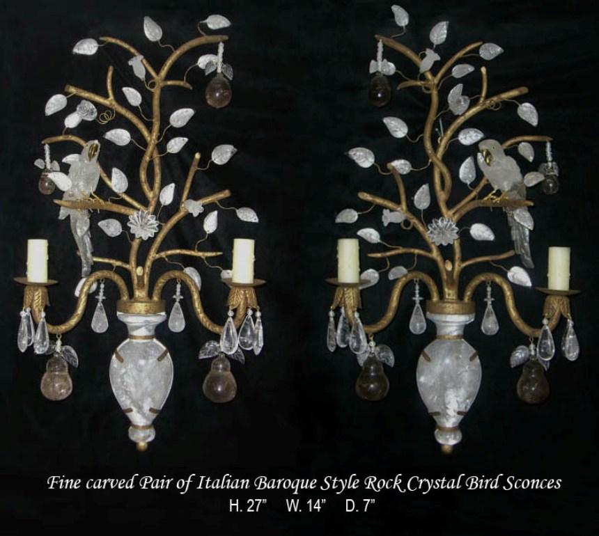 Exquisite pair of French Baguès style hand forged wrought iron two-light sconces.
Both sconces are enhanced with finely hand carved rock crystal opposing phoenix birds on a tree form surrounded by rock crystal floral, leaf, and fruit motif.
In an