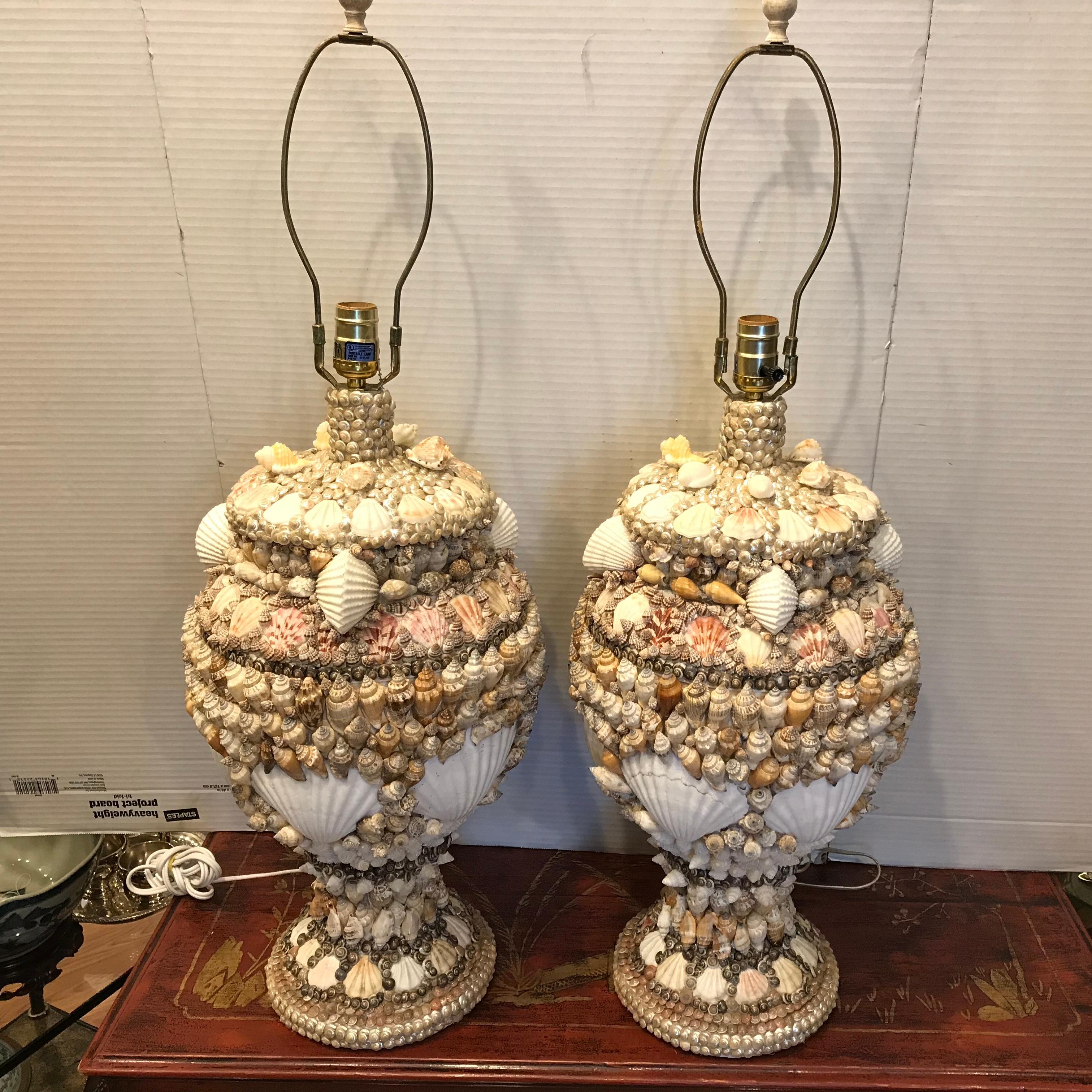 Custom made for a fabulous Palm Beach residence in the late 20th century
- unusual design. A stunning pair of costal motif lamps.
The lamps are generously scaled and proportioned with a myriad of shells.