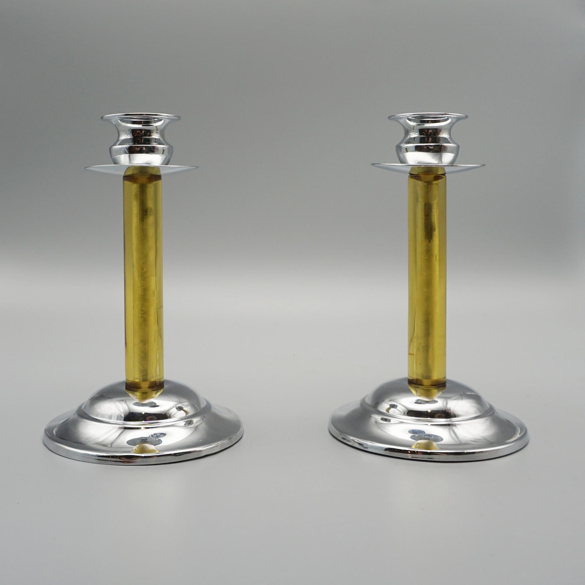 A Pair of Art Deco style candlesticks. A translucent green bakelite stem set over a circular chromed metal base.  

