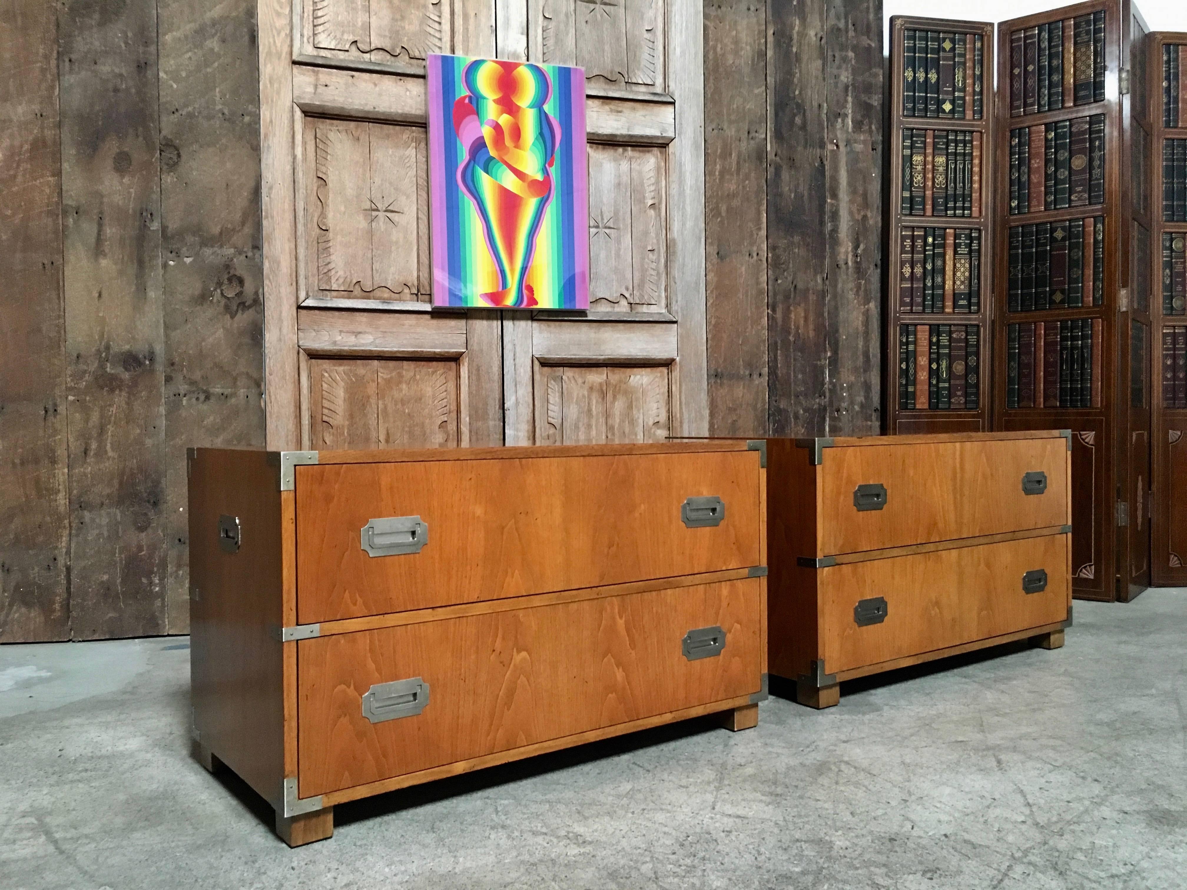 Pair of Baker Campaign style two-drawer dressers cabinets with nickel plated hardware.