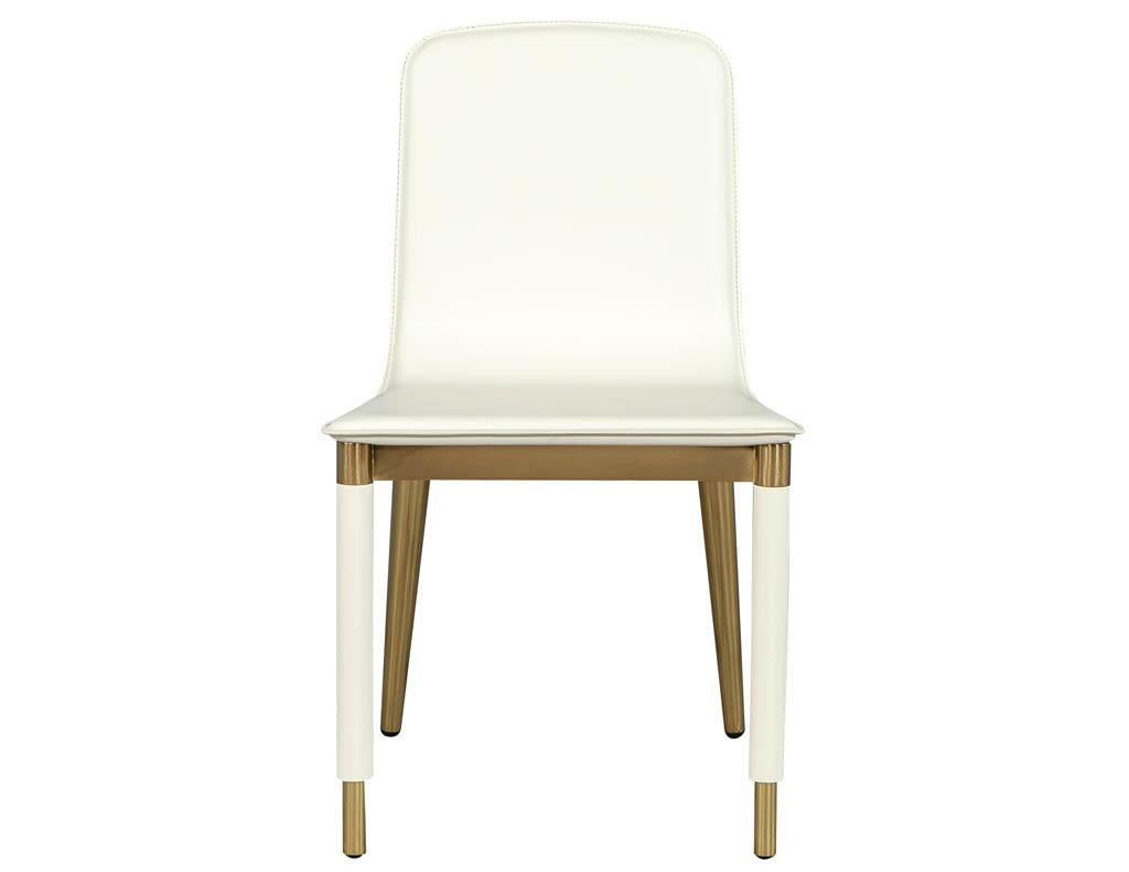 Pair of Baker Folio side chairs in white leather. Leather clad chair with brass accents designed by Laura Kirar for Baker.
Price includes complimentary curb side delivery to the continental USA.
