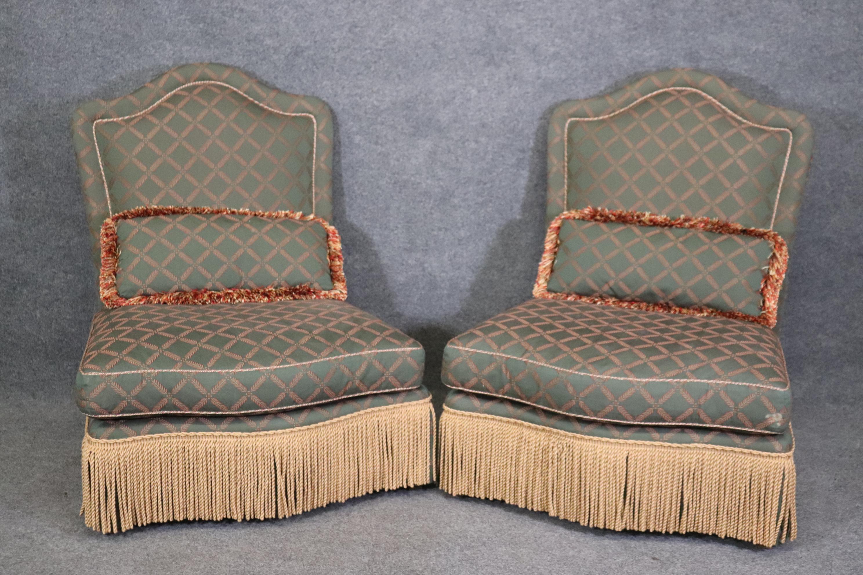 This is a nice pair of rare armless bergere chairs made by Baker Furniture of the USA. They are not perfect but can be made beautiful with some attention on your part. They each measure 40.25 tall x 32.5 wide x 37.25 deep and have a 16.5 inch seat