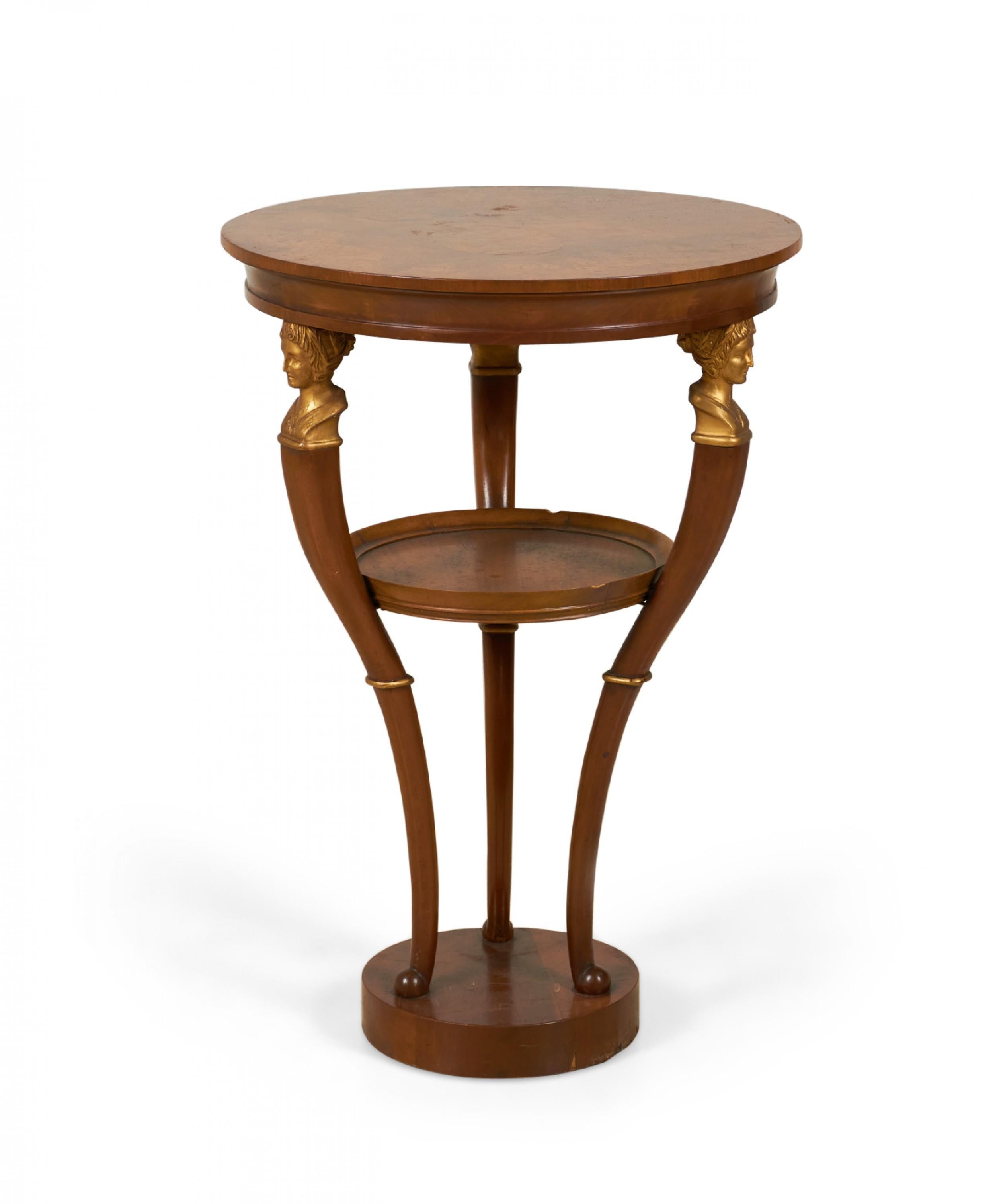 PAIR of Mid-Century Neoclassical-style mahogany end / side tables with circular tops and a stretcher shelves supported by three curved legs topped with brass embellishment busts atop a circular base. (BAKER FURNITURE COMPANY)(PRICED AS PAIR)
