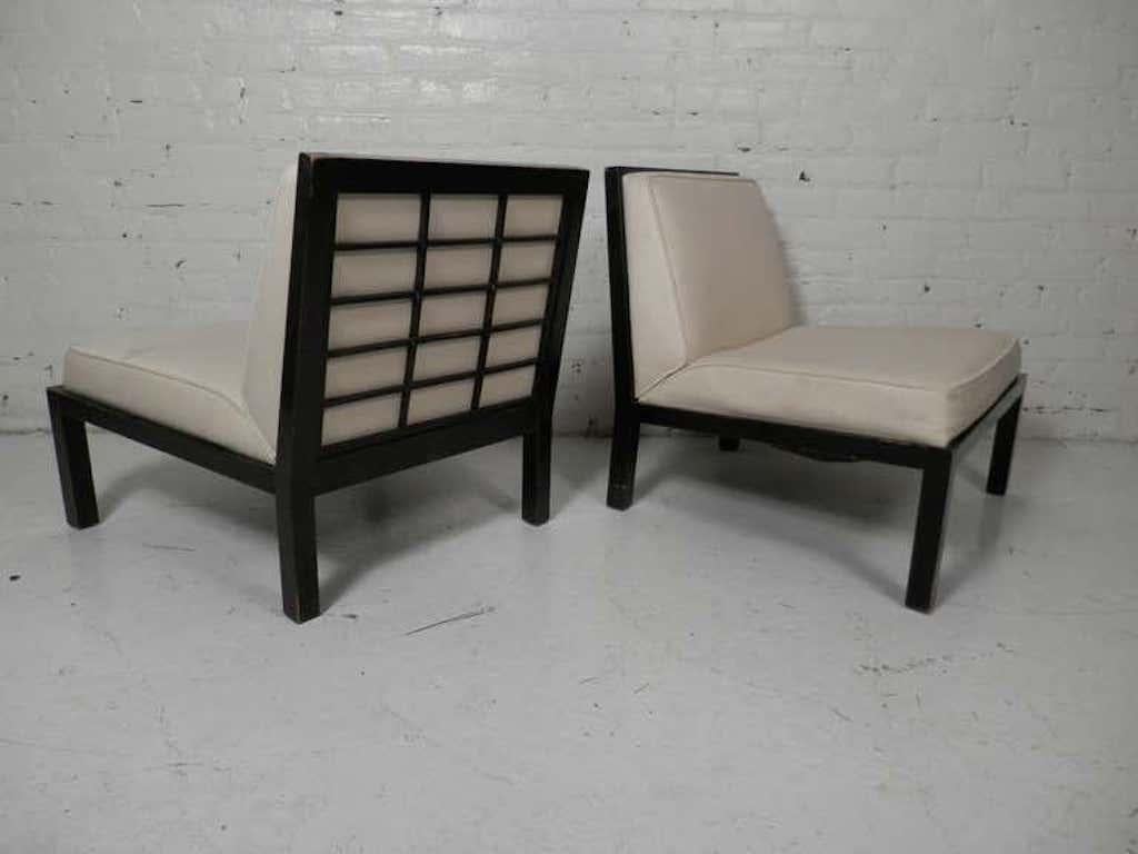 Stunning pair of 1960's Mid-Century Modern Asian inspired slipper chairs with lattice backs. Part of the Far East Collection by Michael Taylor for Baker Furniture Co. 
These slipper chairs feature modernist lines and lattice cut out