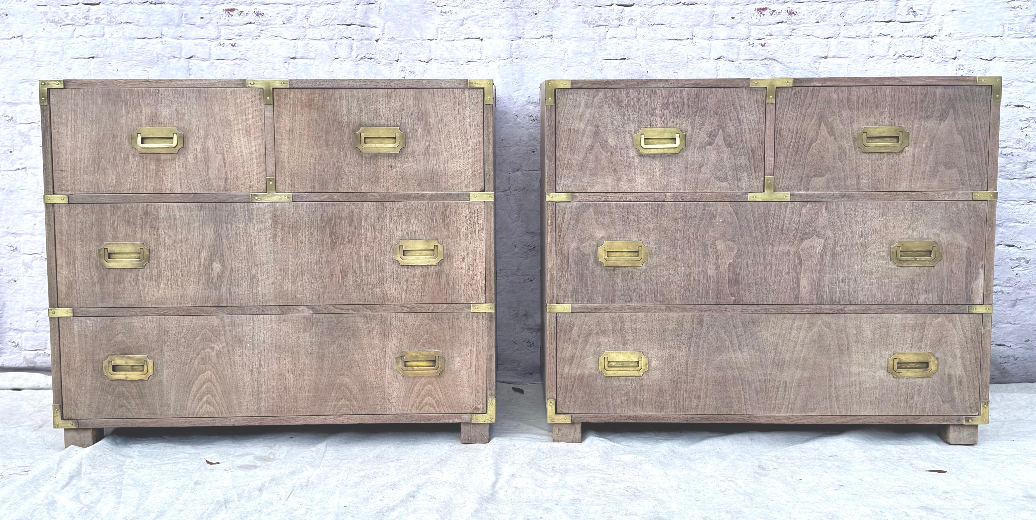 Beautiful pair of Baker Company mid-century modern bleached mahogany four drawer chests with brass inset handles. Baker Furniture is a renowned American furniture maker known for high quality craftsmanship and stylish designs. The bleached wood