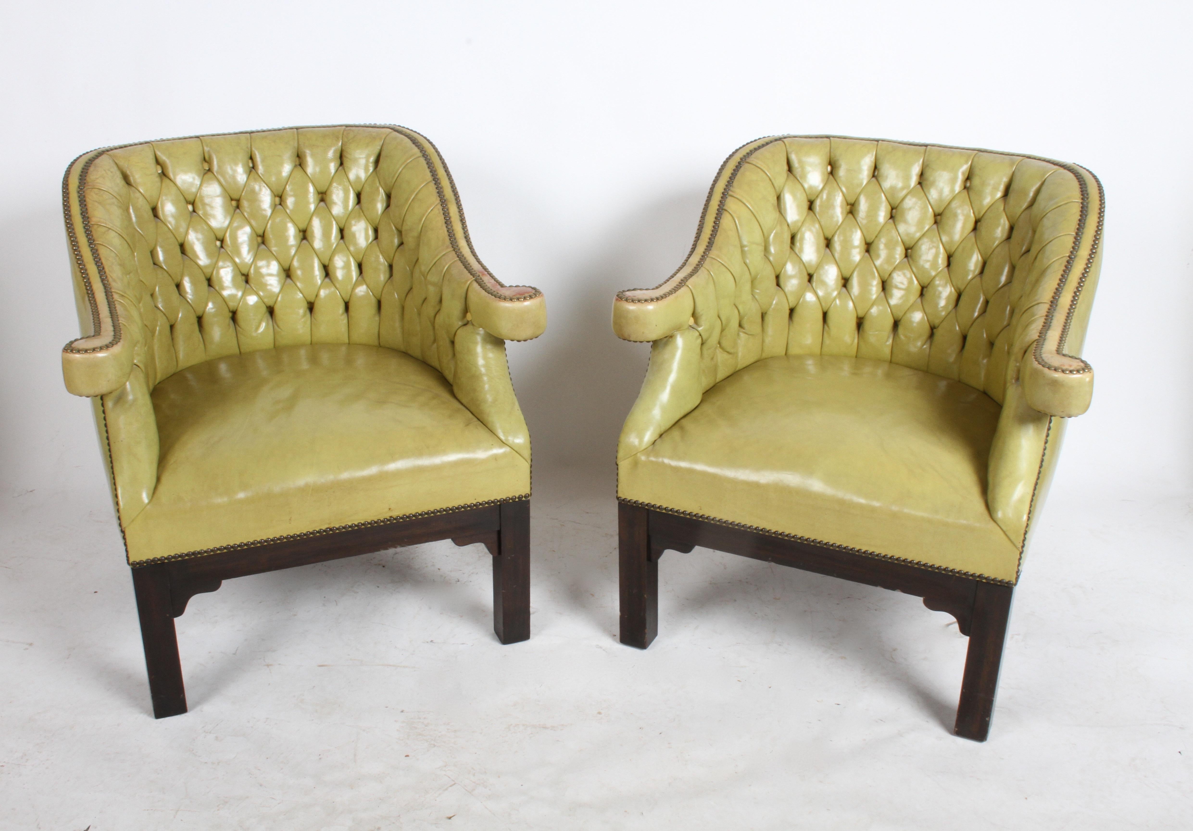 Pair of vintage Chartreuse leather Baker Furniture Company tufted lounge or club chairs. Original leather having brass studs and tufted backs, on dark mahogany Asian inspired frames. Possibly from the Far East collection by Michael Taylor circa