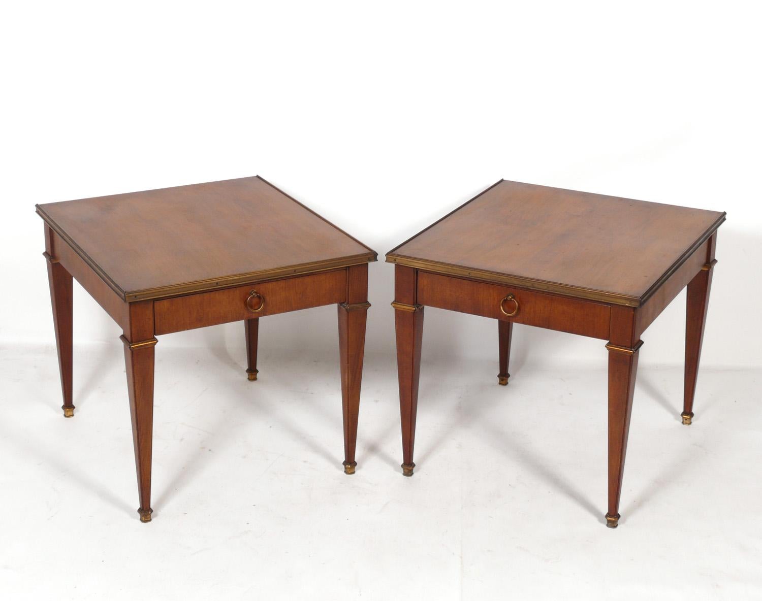 Pair of baker neoclassical side tables or night stands, American, circa 1960s. Elegant brass hardware.