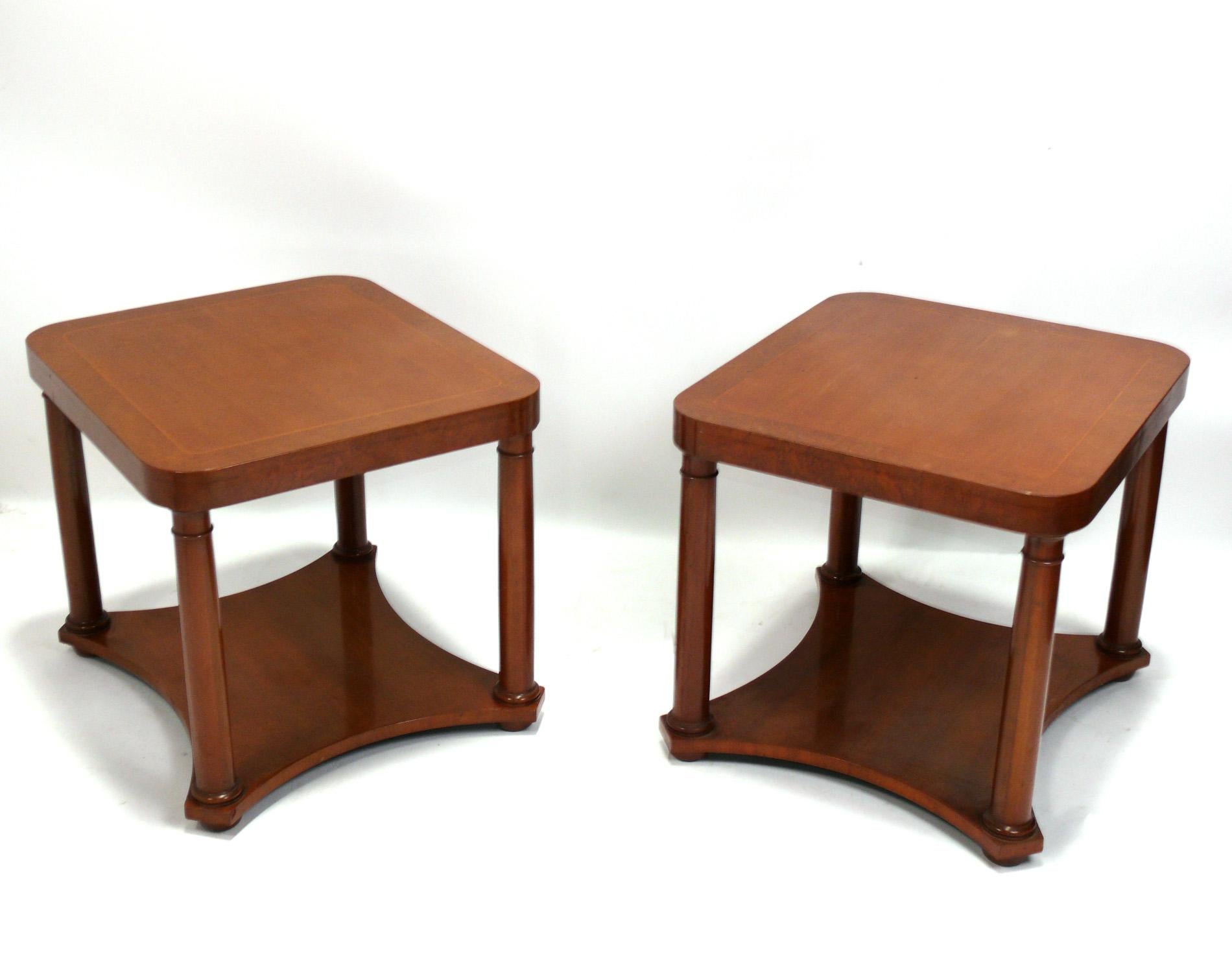 Elegant pair of Neoclassical end tables or night stands, by Baker, American, circa 1980s. Like all Baker furniture, they are extremely well made with beautiful graining to the wood. They are a versatile size and can be used as side or end tables, or