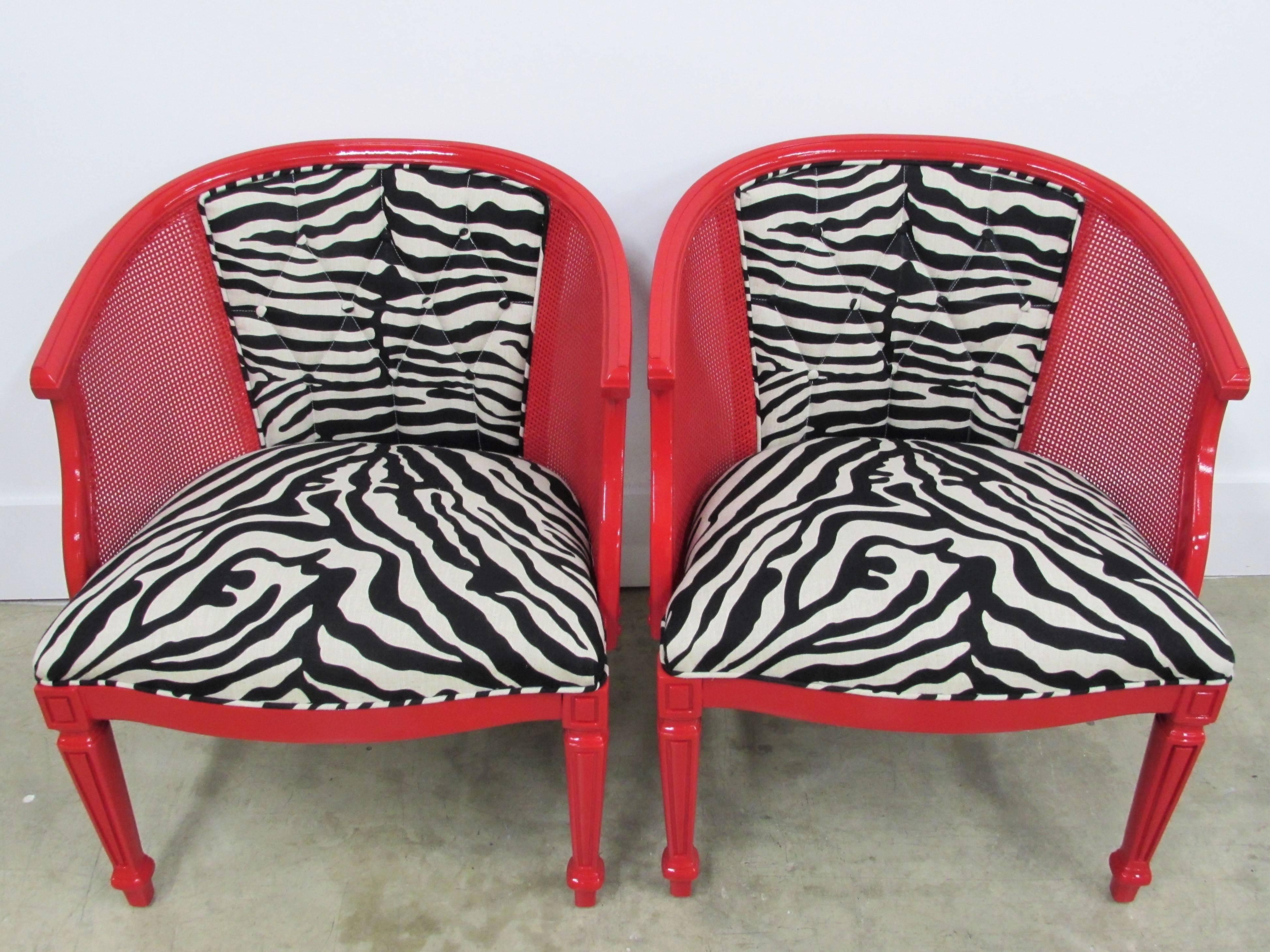 A pair of Baker-style mahogany barrel back cane chairs lacquered In-house in Benjamin Moore Heritage red gloss finish, newly upholstered in William Sonoma Linen Zebra fabric, the back is tufted in a diamond pattern with buttons and single