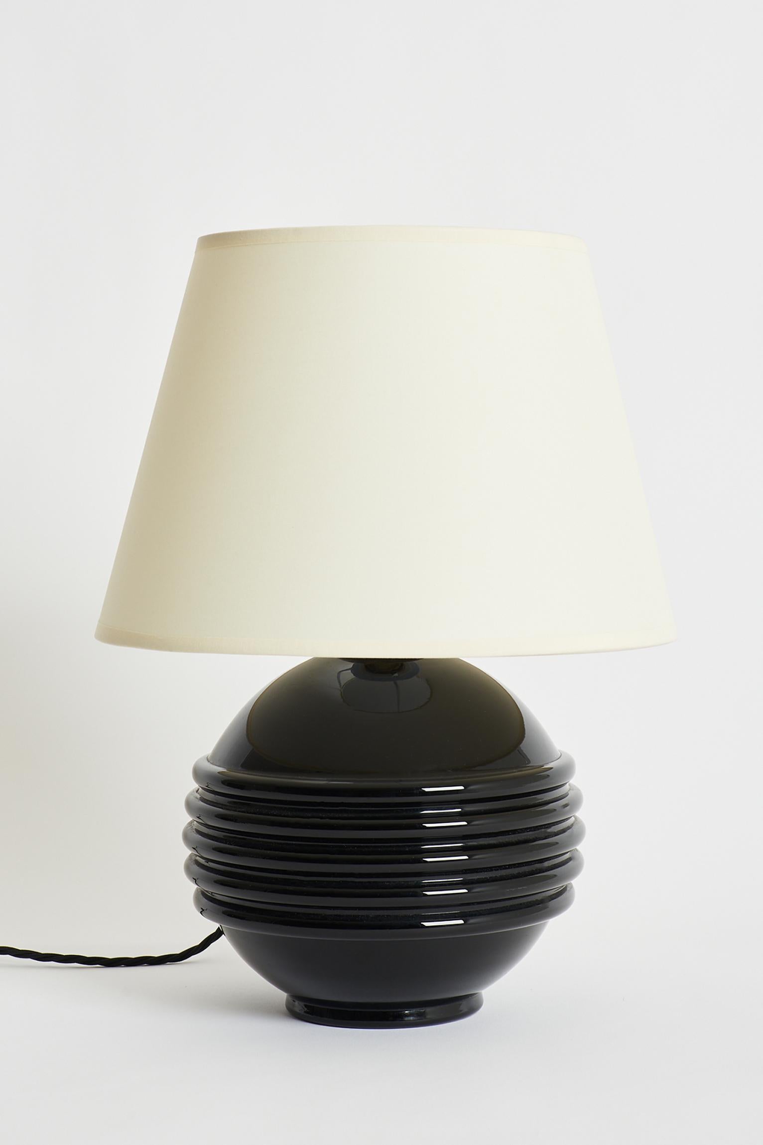 A pair of black opaline glass table lamps by Jacques Adnet (1901-1984).
France, Circa 1930.
Measures: With the shade: 43 cm high by 30 cm diameter.
Lamp bases only: 26 cm high by 21 cm diameter.