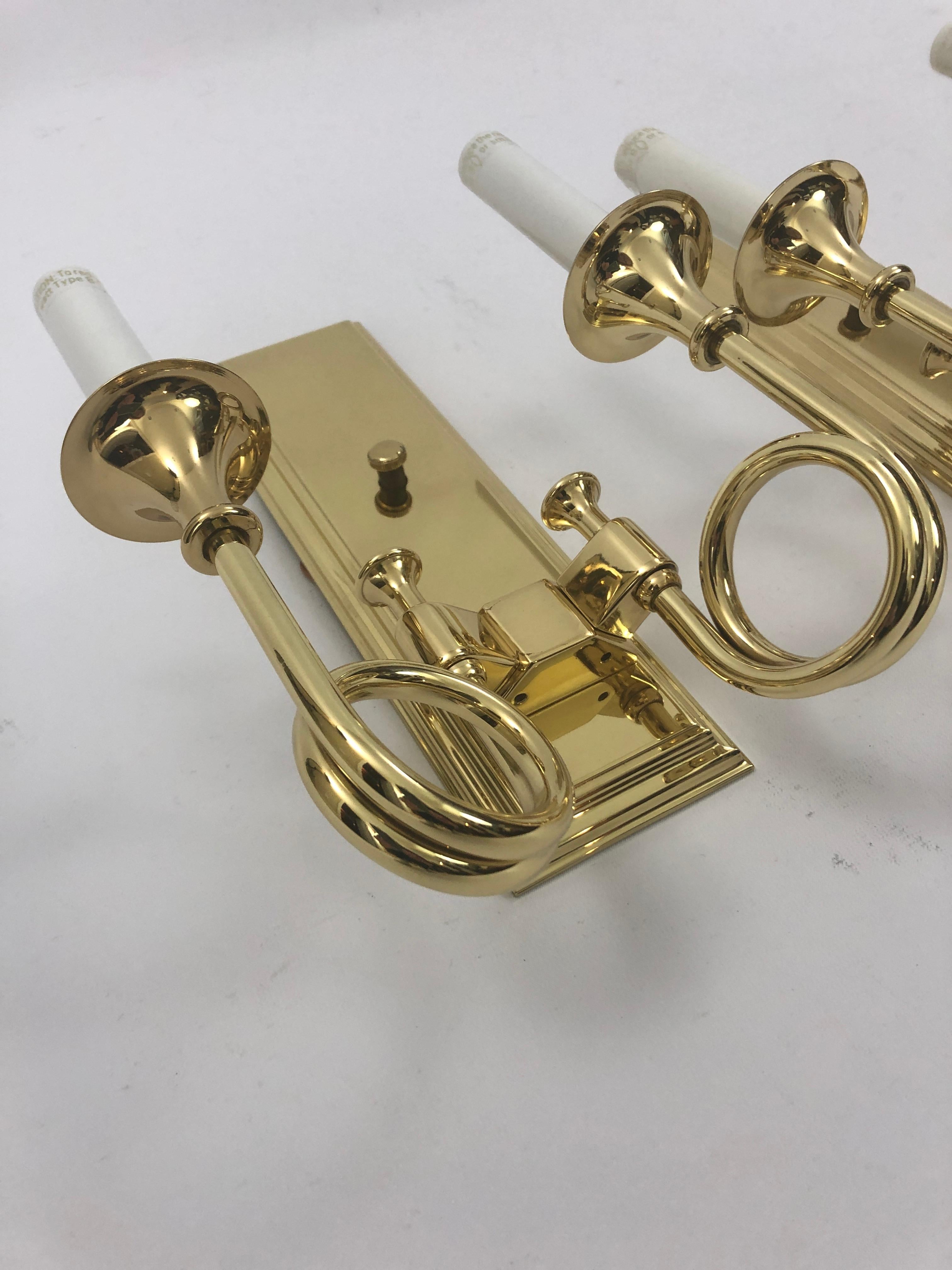 A great looking pair of Baldwin brass wall sconces each having two decorative horn arms with 40 watt sockets.