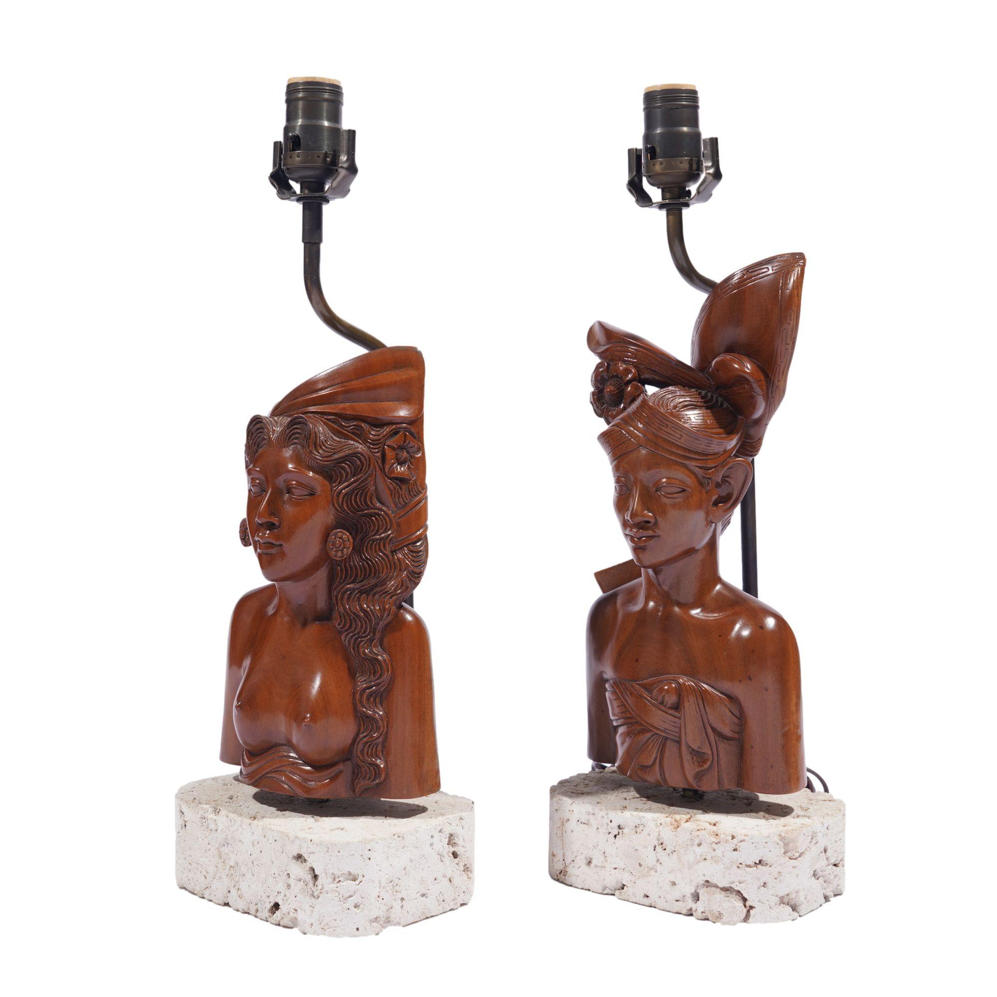 Pair of exceptional and finely carved busts of a man and a woman in traditional Indonesian head scarves. Both busts were carved by the same hand, in Klungkung wood (a Balinese hardwood). The works are signed on the underside and mounted on custom