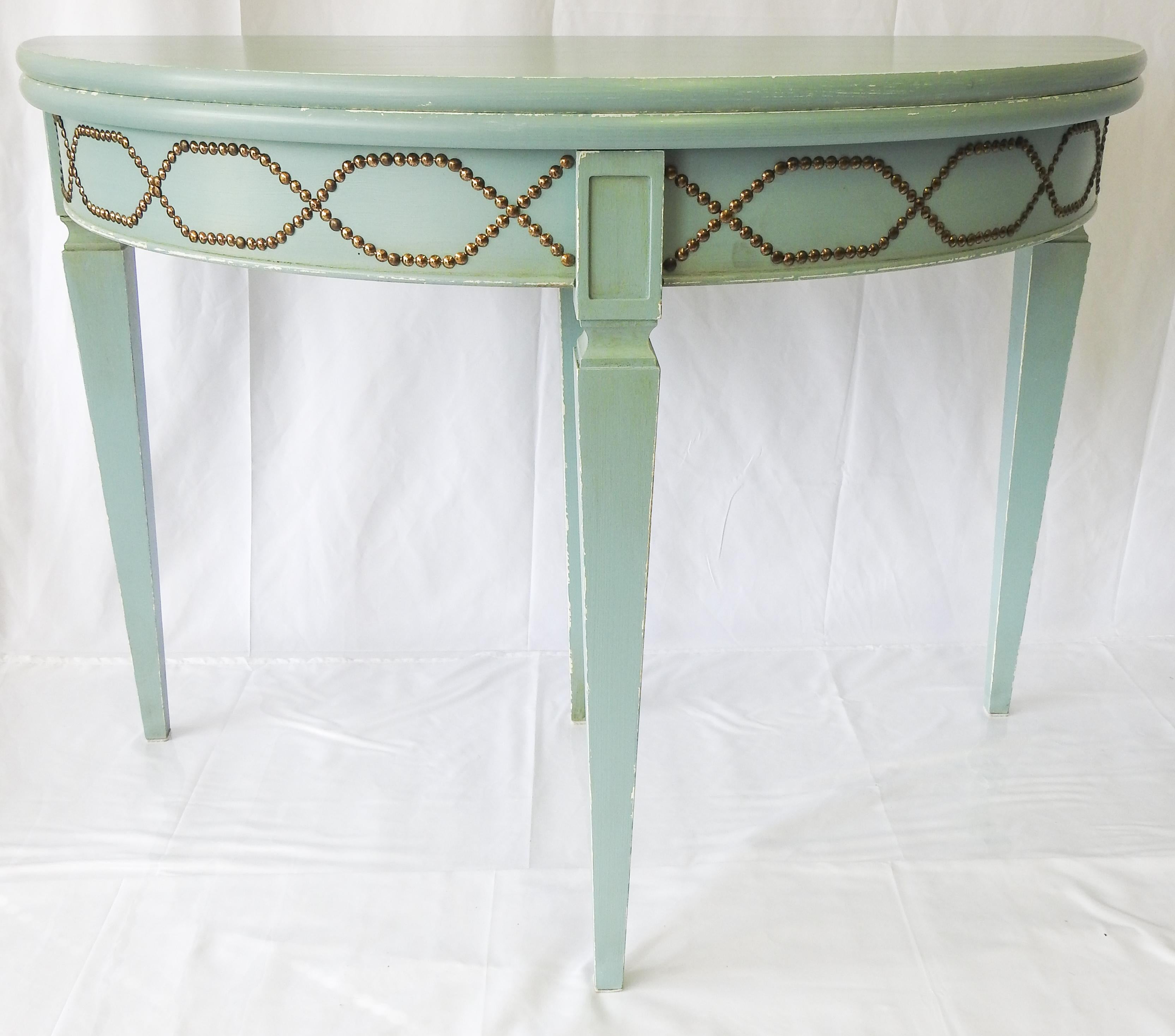 pair of Ballard designs demilune table. Sitting on a square tampered leg that rises up to a tacked skirt. The tables can be used as demilune or can be opened and used a round tables. The back center leg pulls out to support the table when it is