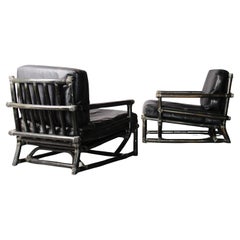 Pair of bamboo and black leather armchairs