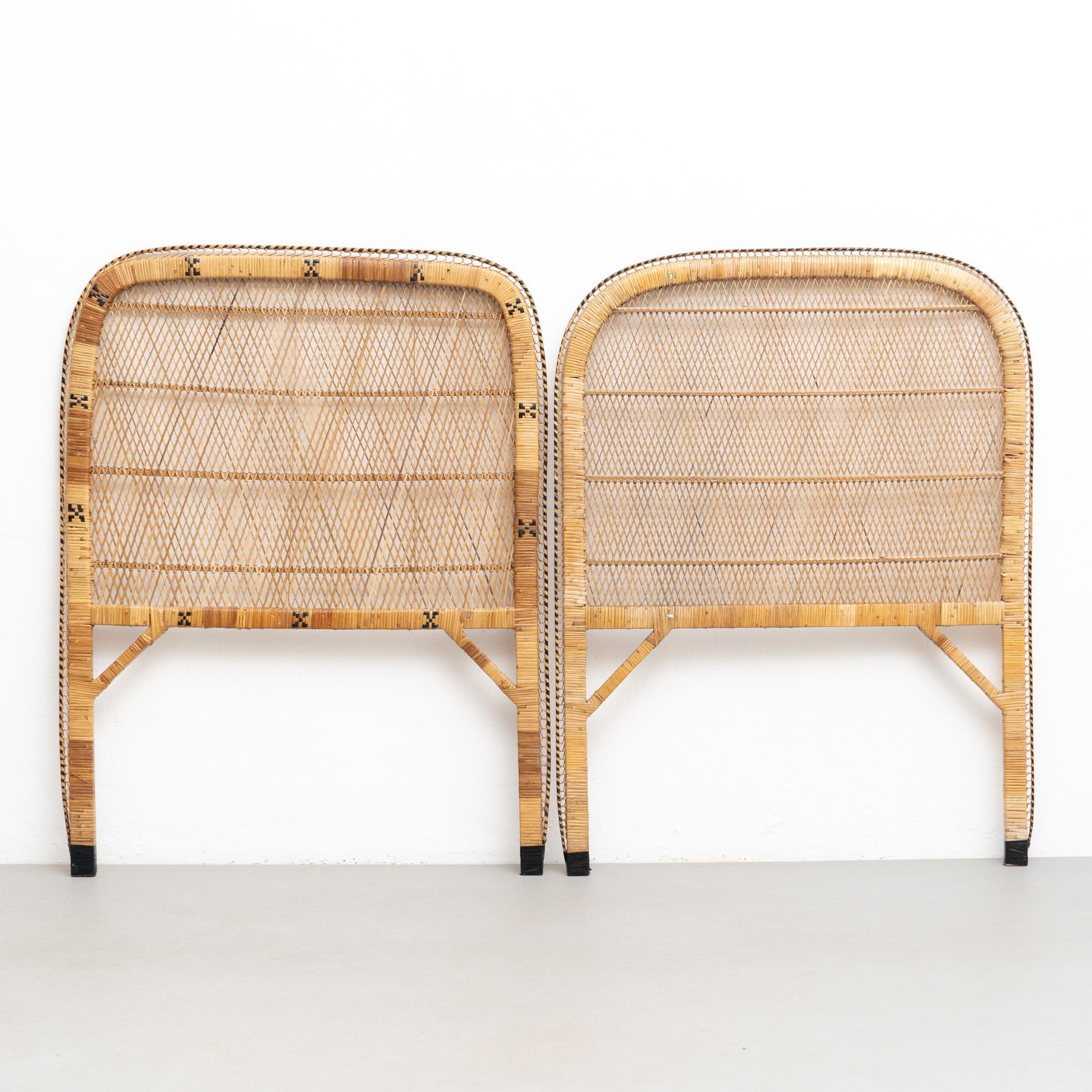 Pair of Mid-Century Modern bamboo and rattan headboard, circa 1960.    Traditionally manufactured in Philippines.    By unknown designer.    In original condition with minor wear consistent of age and use, preserving a beautiful patina.   