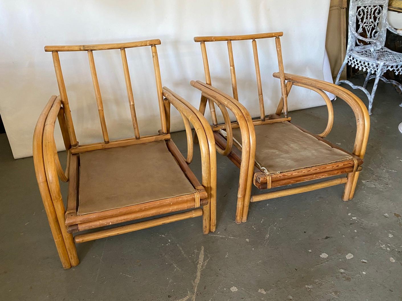 Pair of generously proportion and low to the ground American organic modern rattan wrapped bamboo armchairs. Comfortable. Smooth linear and curved lines. These bentwood style bamboo chairs are suitable for year round use in dry outdoor climates.