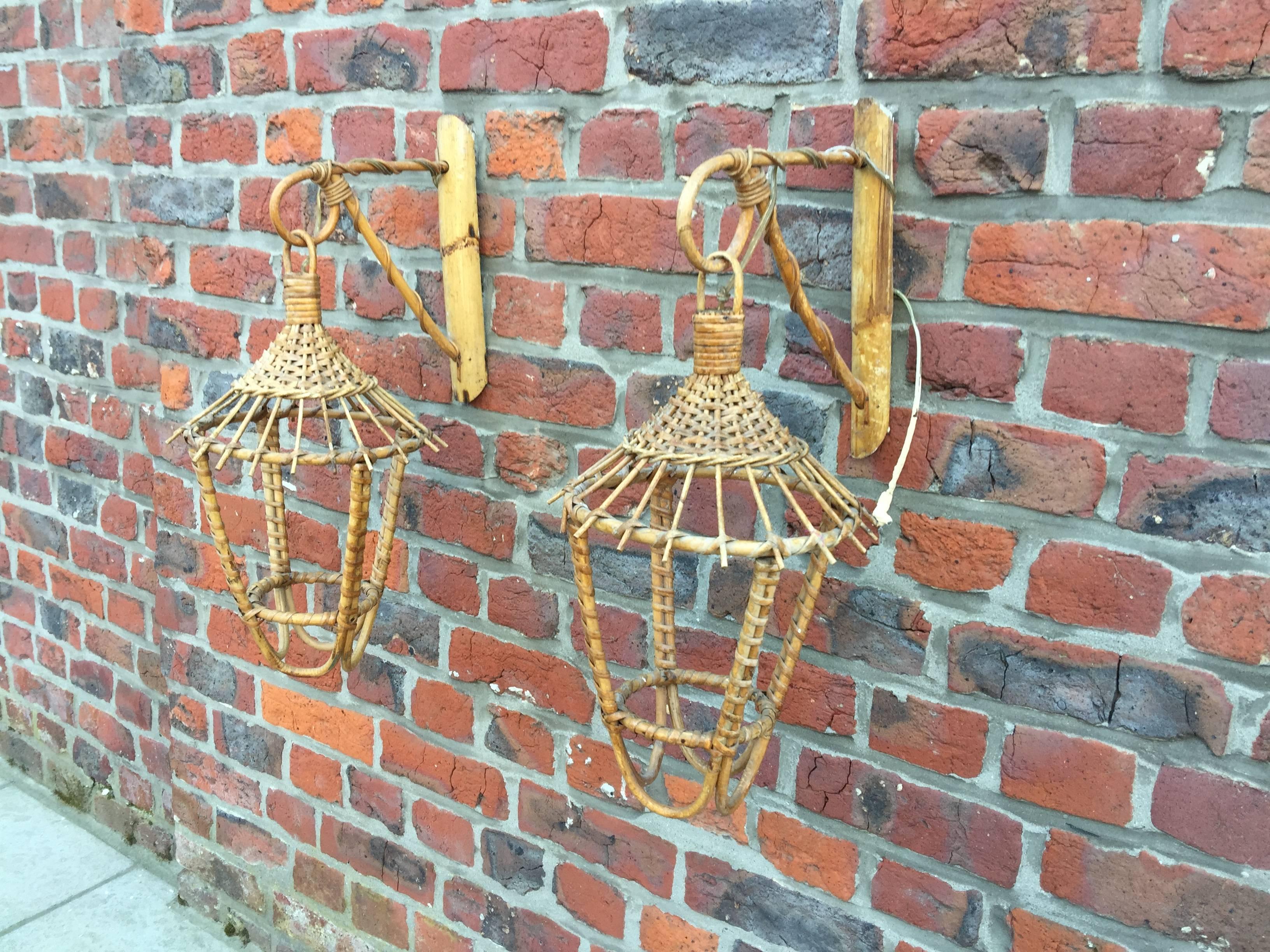 Pair of bamboo and rattan sconces, circa 1950.