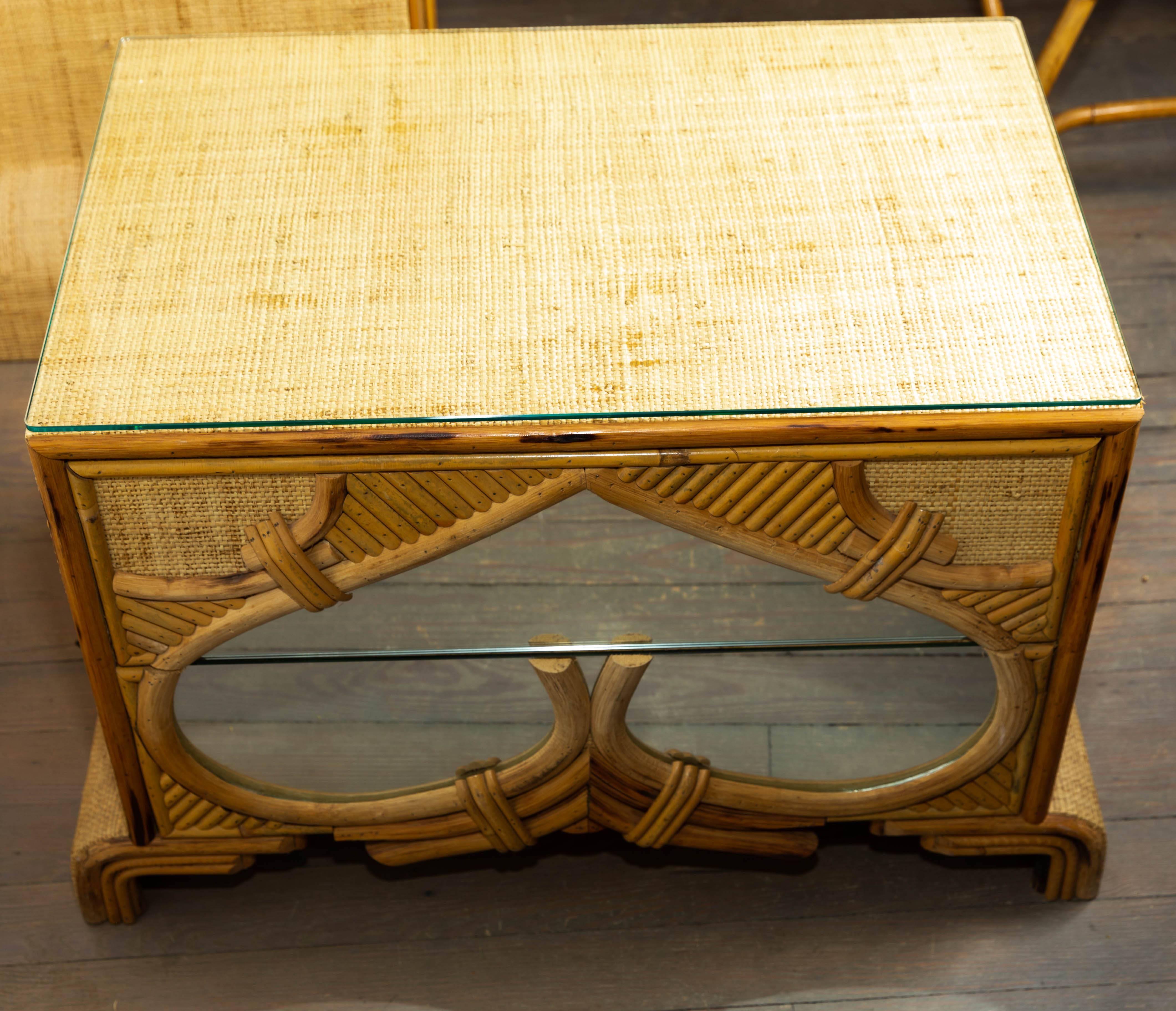 Pair of bamboo and reed two-drawer chests with glass tops.