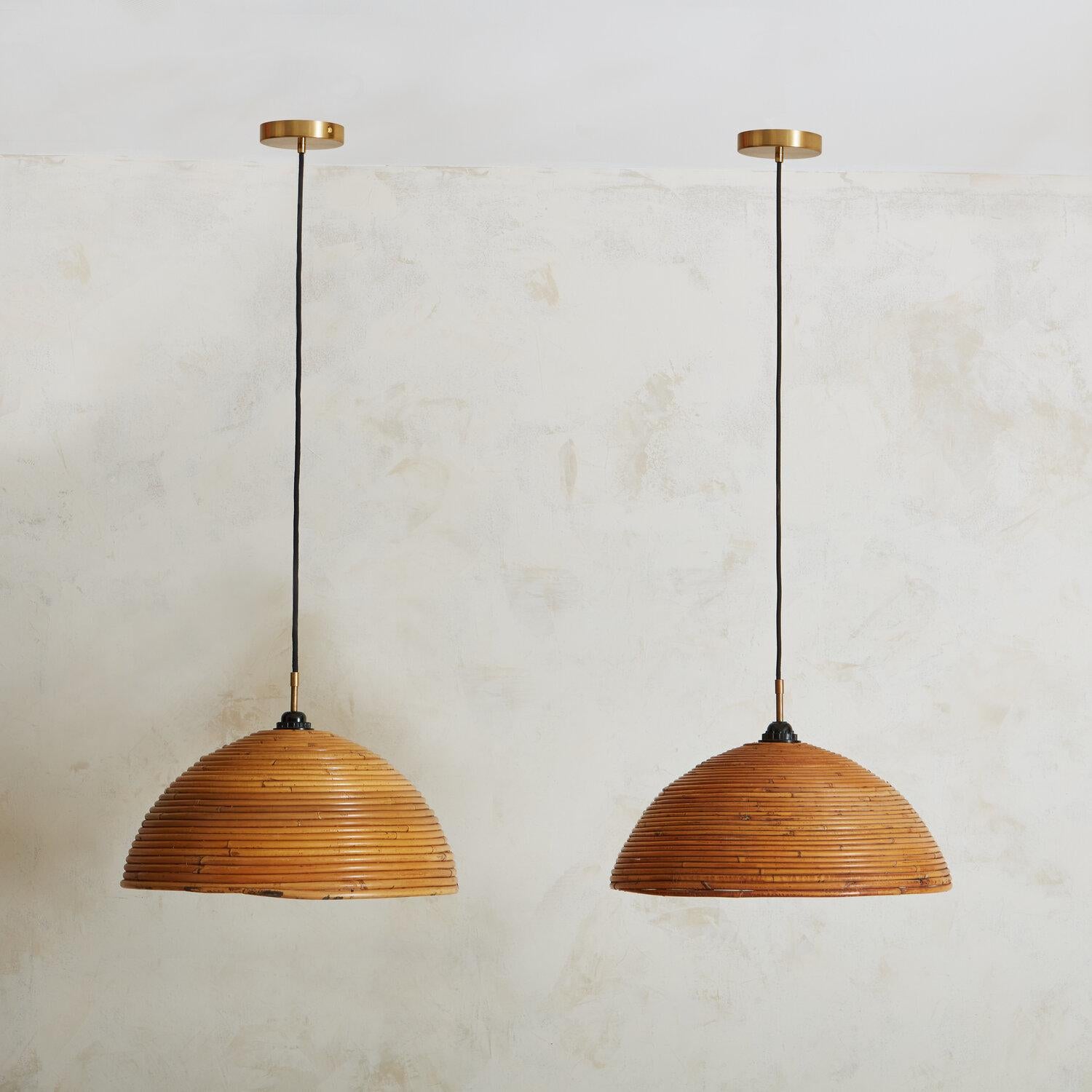 A pair of mid-century bamboo pendant lights, reminiscent of designs by Gabrielle Crespi. These pendants feature a black woven cord and new brass canopies, mixing both organic and contemporary elements. Sourced in Spain. 

Dimensions: 10.5” height;