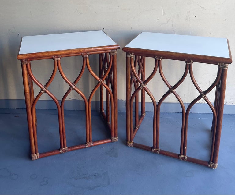 A very nice pair of bamboo and white laminate top end tables by McGuire, circa 1980s. Beautiful craftsmanship and sturdy construction on these open bamboo base tables. They are in very good vintage condition and measure 21.25