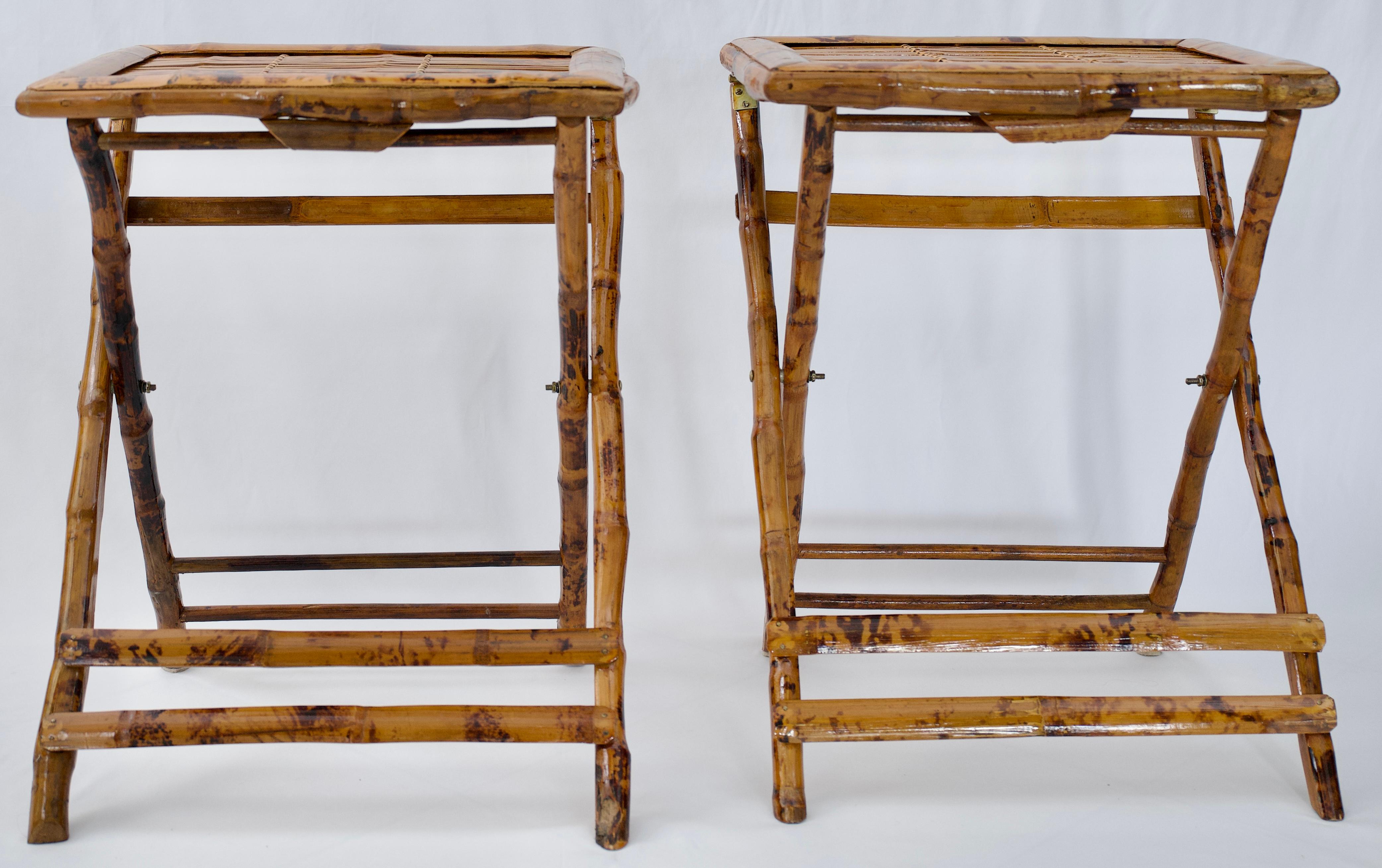 A good quality pair of bamboo end tables or side tables. The frame is very interesting and unusual because the tops fold. Made from imported bamboo these end tables feature splayed legs, joined by stretchers. This is a wonderful example of design