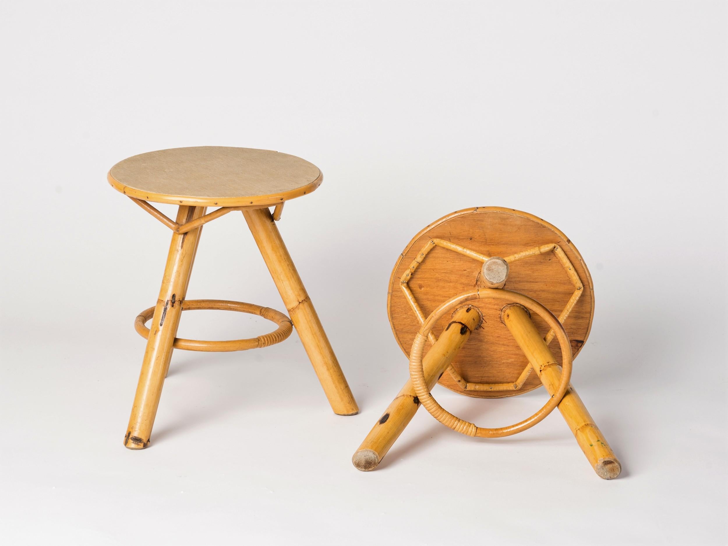 Pair of tripod gueridons in bamboo and vinyl covered top. A third identical gueridons is available. Sturdy and in good vintage condition. These gueridons will ship from France and can be returned to either France or to a Long Island City