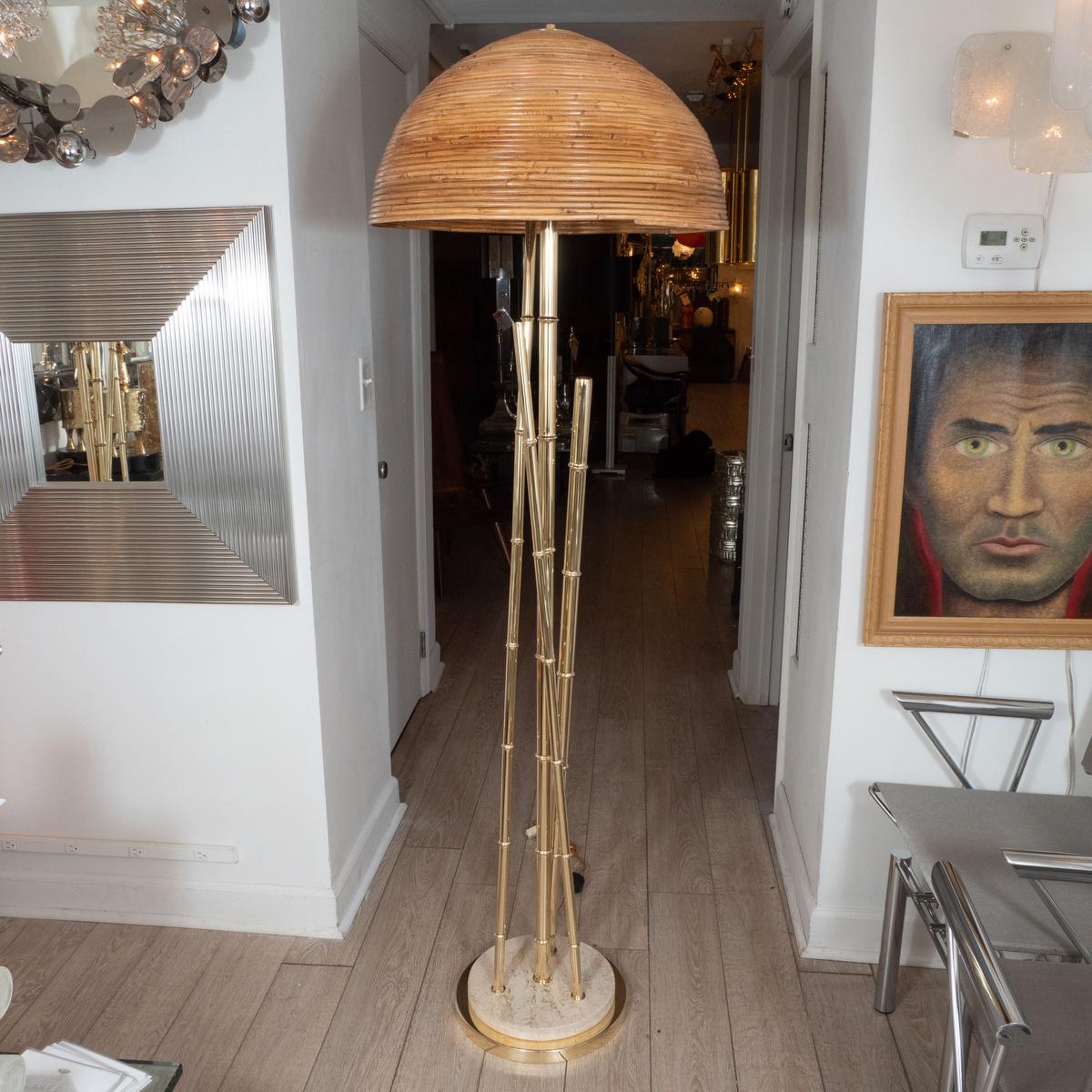 Pair of brass faux bamboo floor lamps with bamboo shades and travertine details at base.