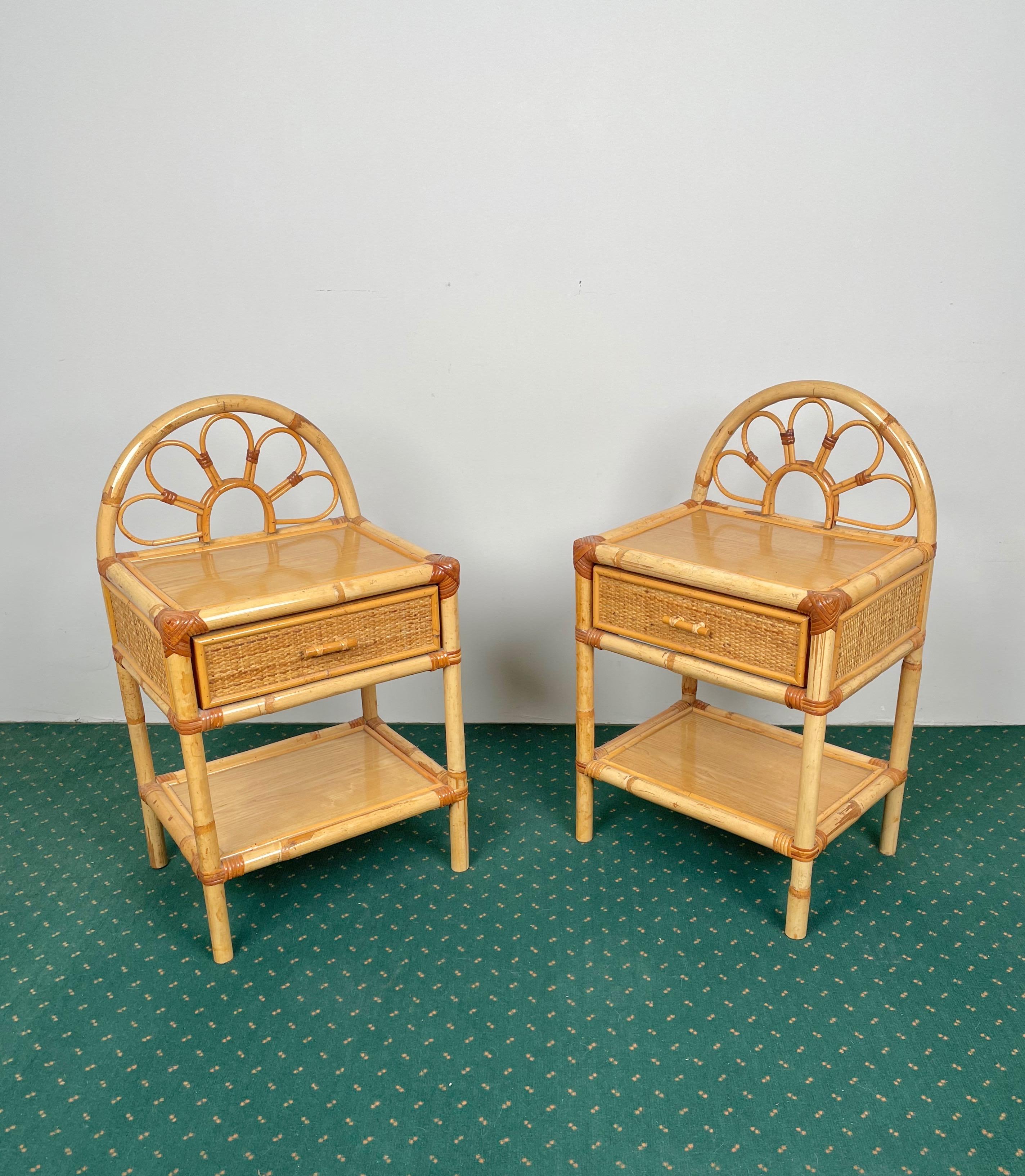 Pair of beside tables in bamboo and rattan, each featuring a drawer embellished with bamboo doodles and a lower shelf. Made in Italy in the 1970s.