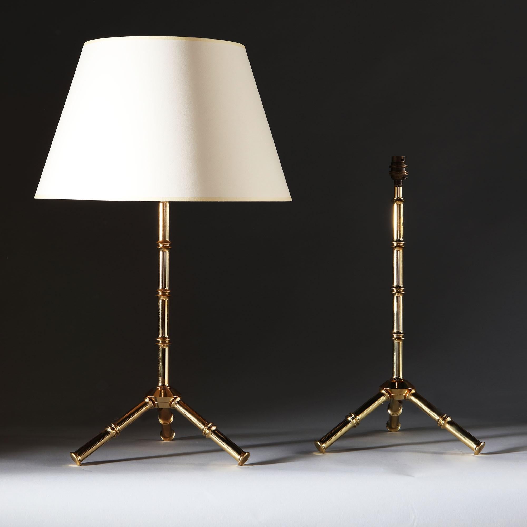 A pair of bamboo simulated brass lamps, standing on a tripod base.

Currently wired for the UK. Please enquire for rewiring services.

Please note: lampshades not included.