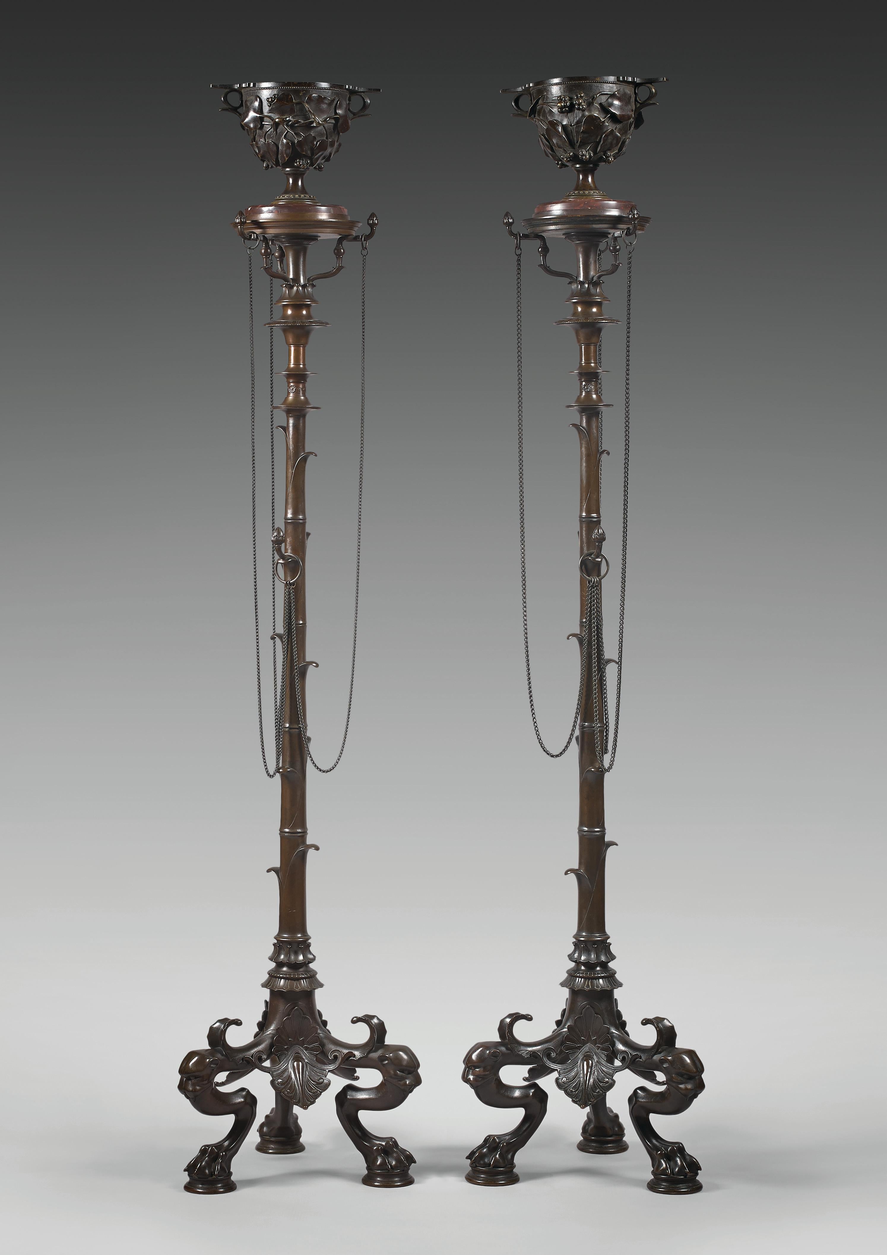 A similar model presented at the 1855 Paris Universal Exhibition

Total height : 154 cm (60 5/8 in.) ; Width : 33 x 33 cm (13 x 13 in.)
Cup : height 17 cm (6 ¾ in.)

Beautiful pair of bronze stands also named Bamboo candelabra. Each rests on