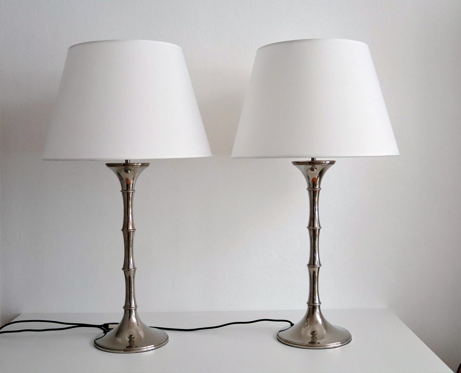 Gorgeous pair of table lamps with very nice patina made of nickel with new white lampshades.
The lamp's shape reminds to a thick bamboo branch.
The lamps have been designed by Ingo Maurer, Germany, in the 1970s.
They have been checked and cleaned