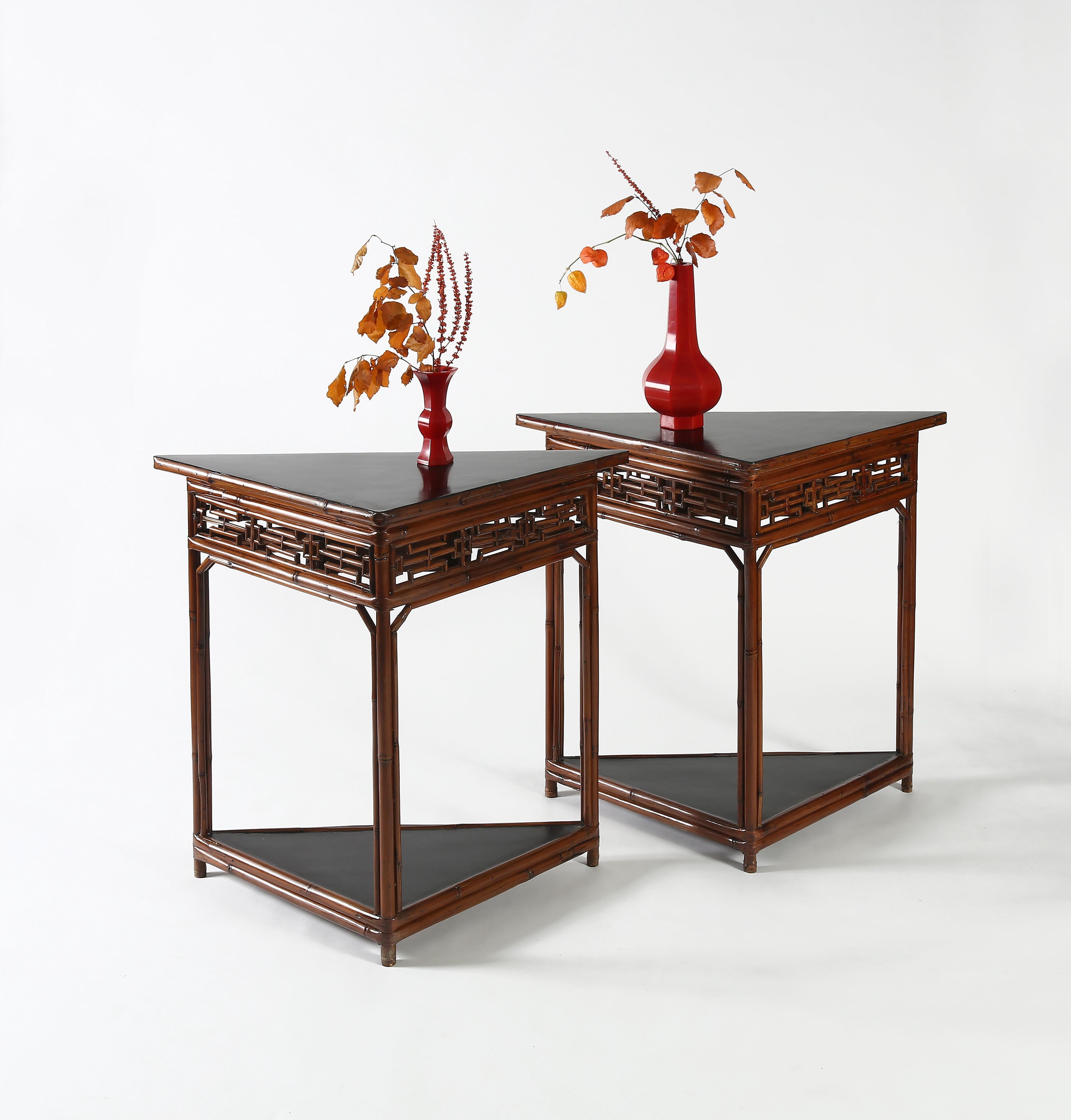 Each triangular table with black lacquer wooden top, supported on three legs with wrapped-around stretchers enclosing a lattice apron and a hidden drawer on one side, arch apron spandrels bracing the legs, reinforced by a bottom wooden panel with