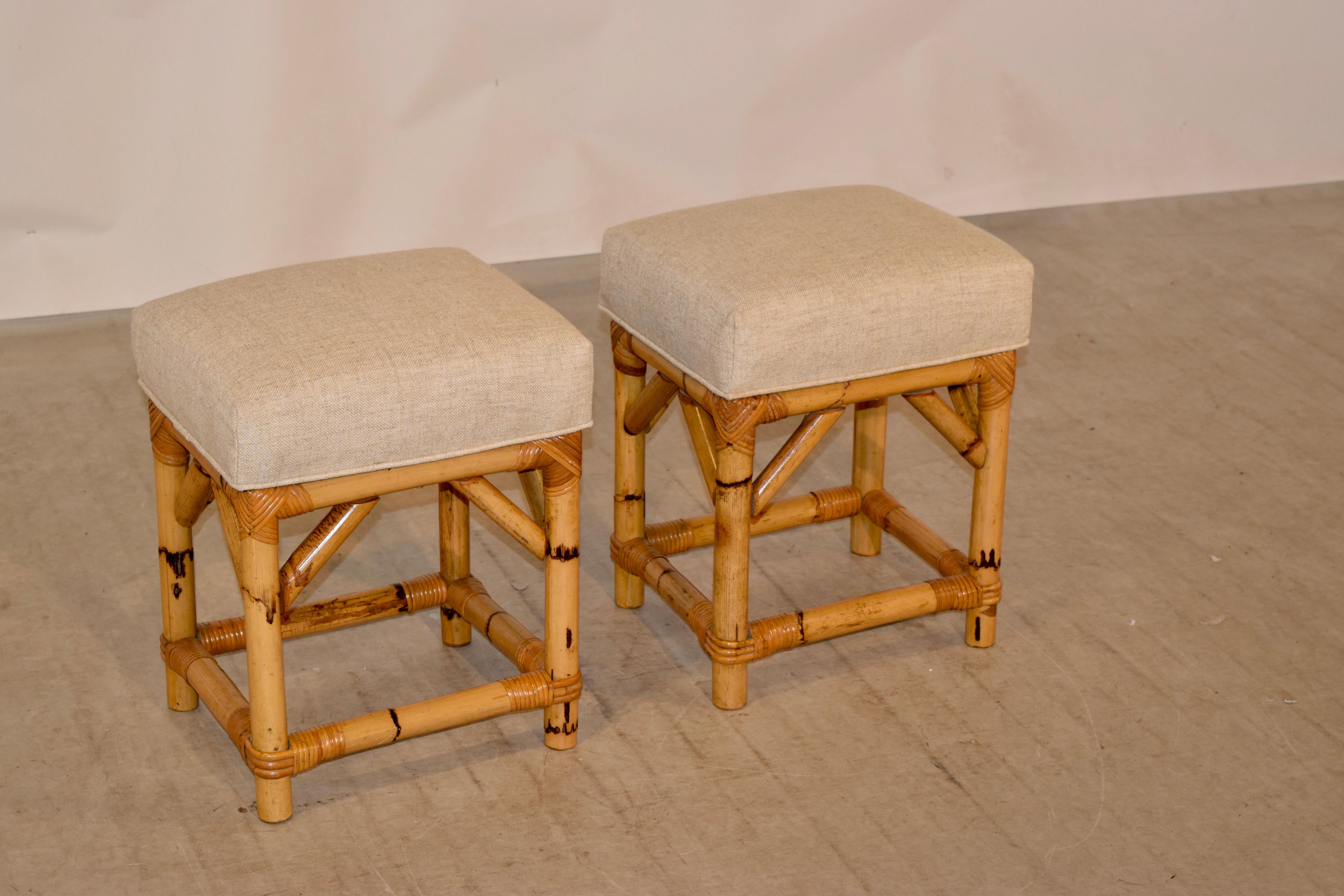 Pair of bamboo stools from England with newly covered seats in linen.