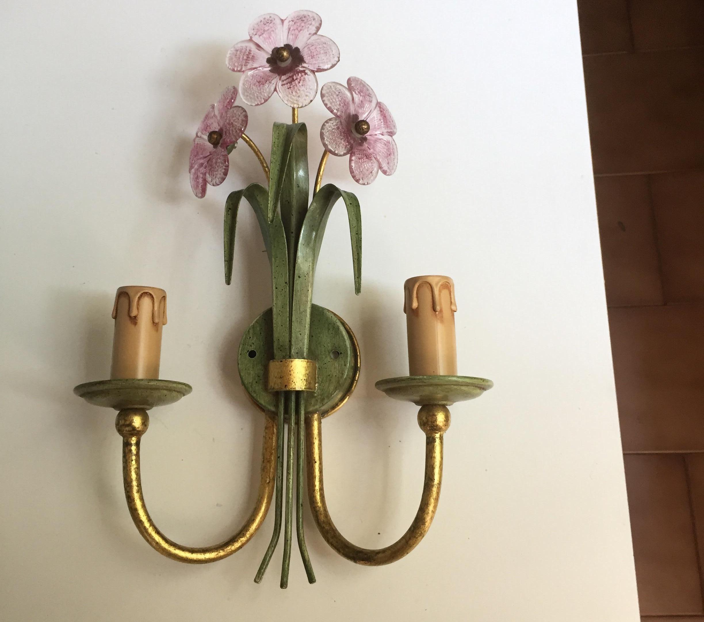 Vintage pair of Italian iron sconces, two green painted and partially gilt two-light sconces by Banci, manufactured by Banci Firenze, decorated with pink crystal flowers. 
These lovely original Italian iron wall-lights are realized with a gilded and