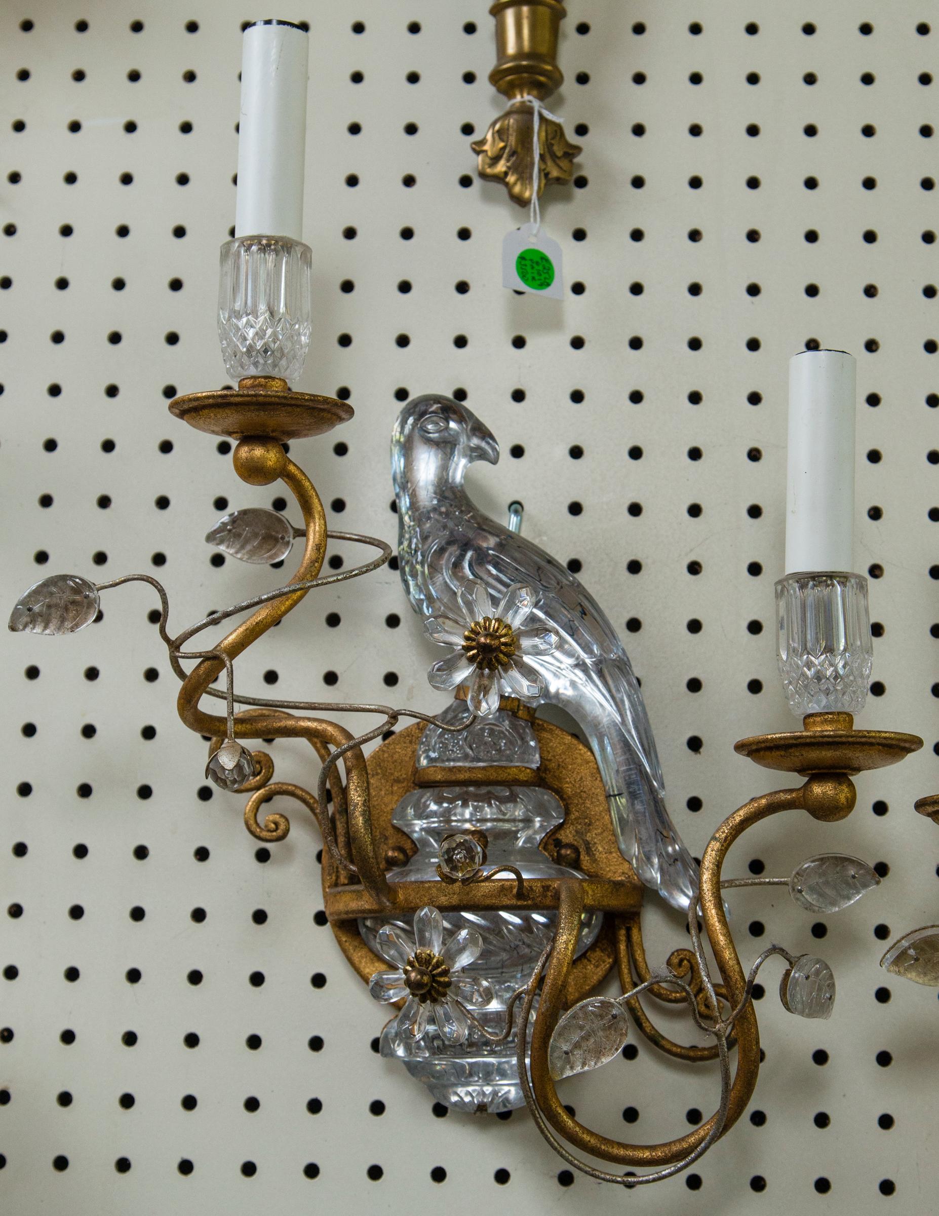 A true pair with each bird facing a different direction. Two arms, baubeches, rosette, and round back plates in gold tone metal. The birds and candle cups in crystal. Wired.