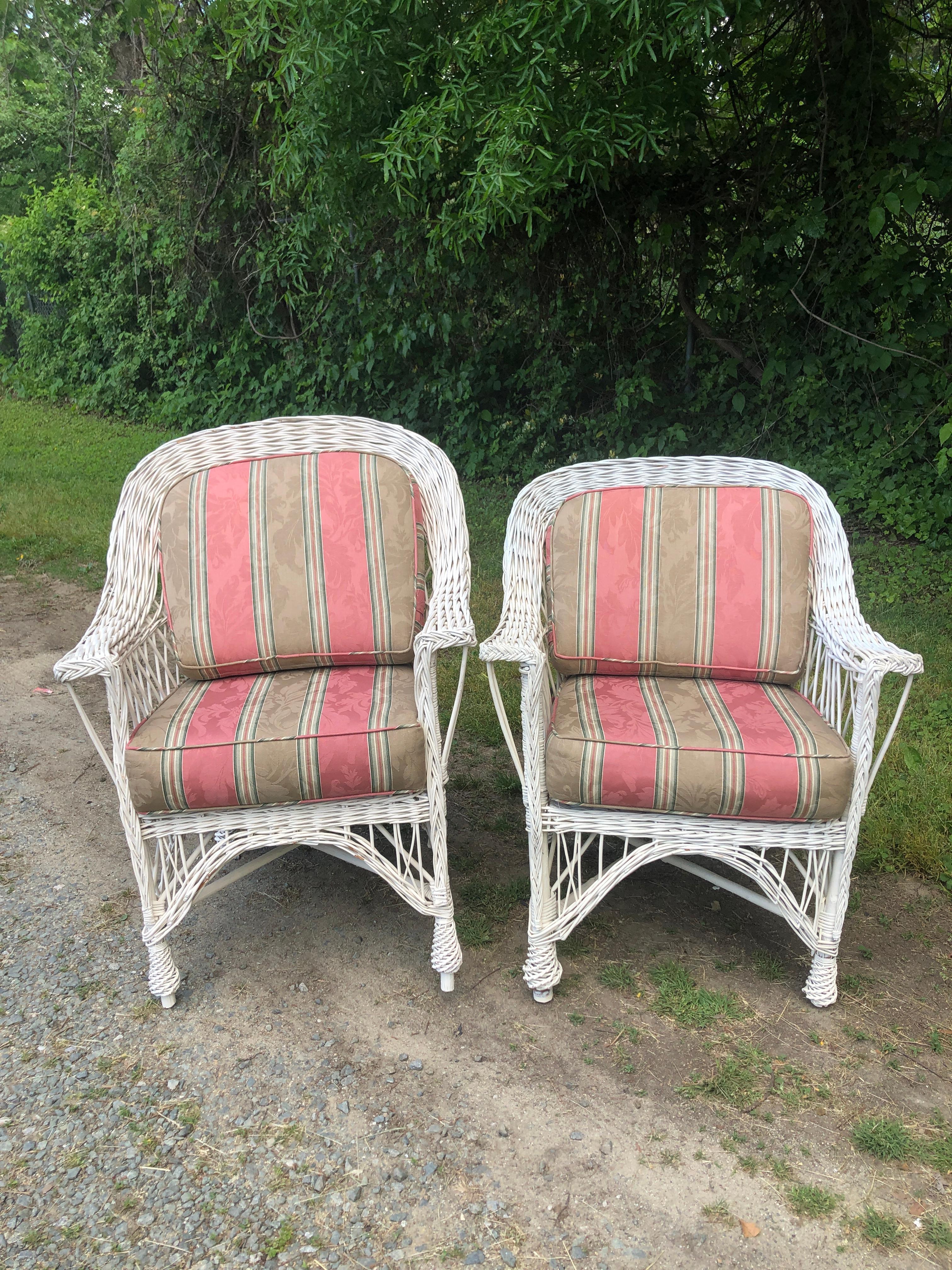 Pair of Bar Harbor White Wicker Armchairs. We have another pair of the same chairs in the same design. They are in a separate listing. They all came out the same house. The seats and back cushion upholstery are in good condition.
Please contact us