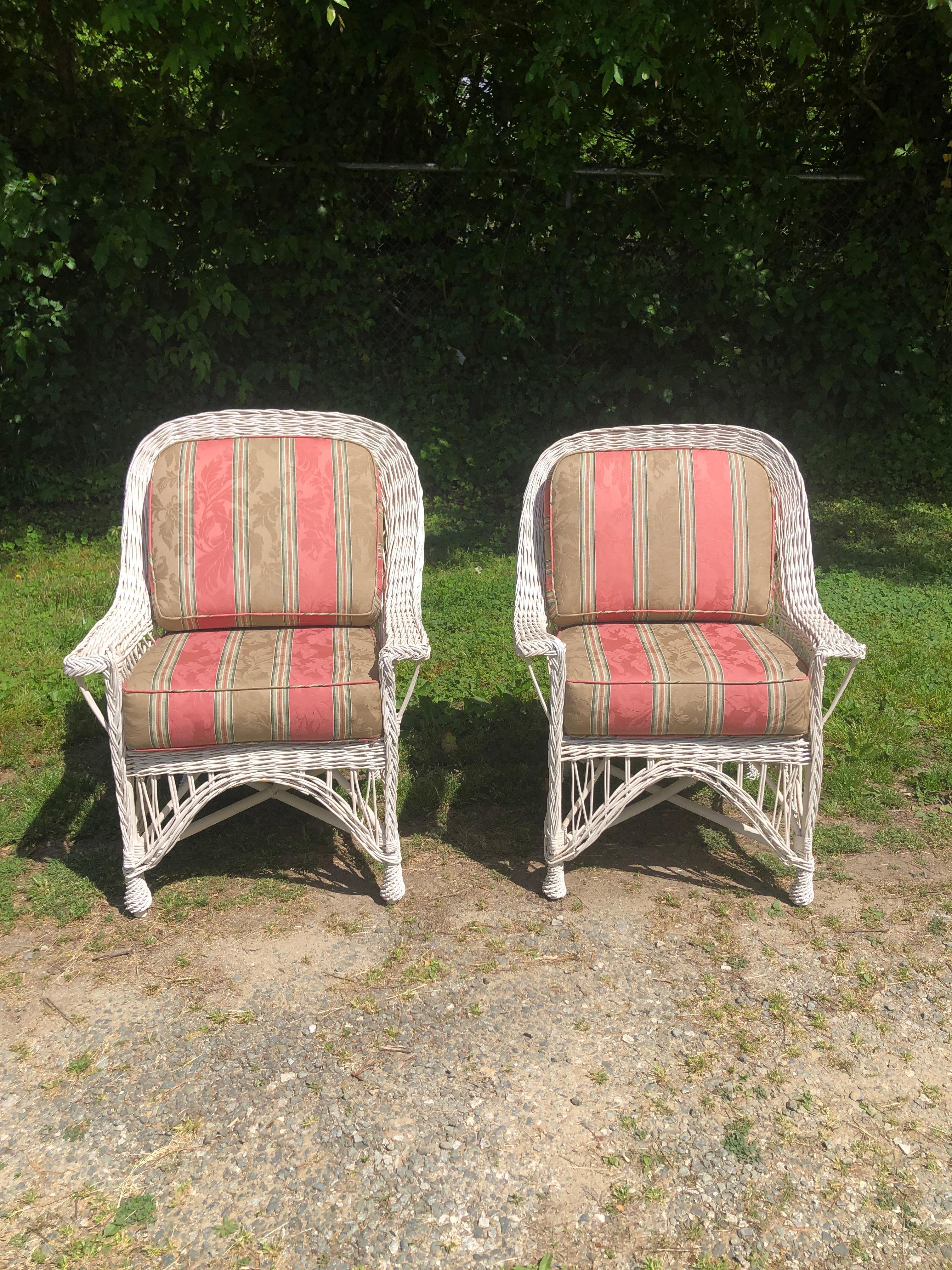 Pair of Bar Harbor White Wicker Armchairs. We have another pair of the same chairs. They are in a separate listing. They all came out the same house. The seats and back cushion upholstery are in good condition. Please contact us for competitive