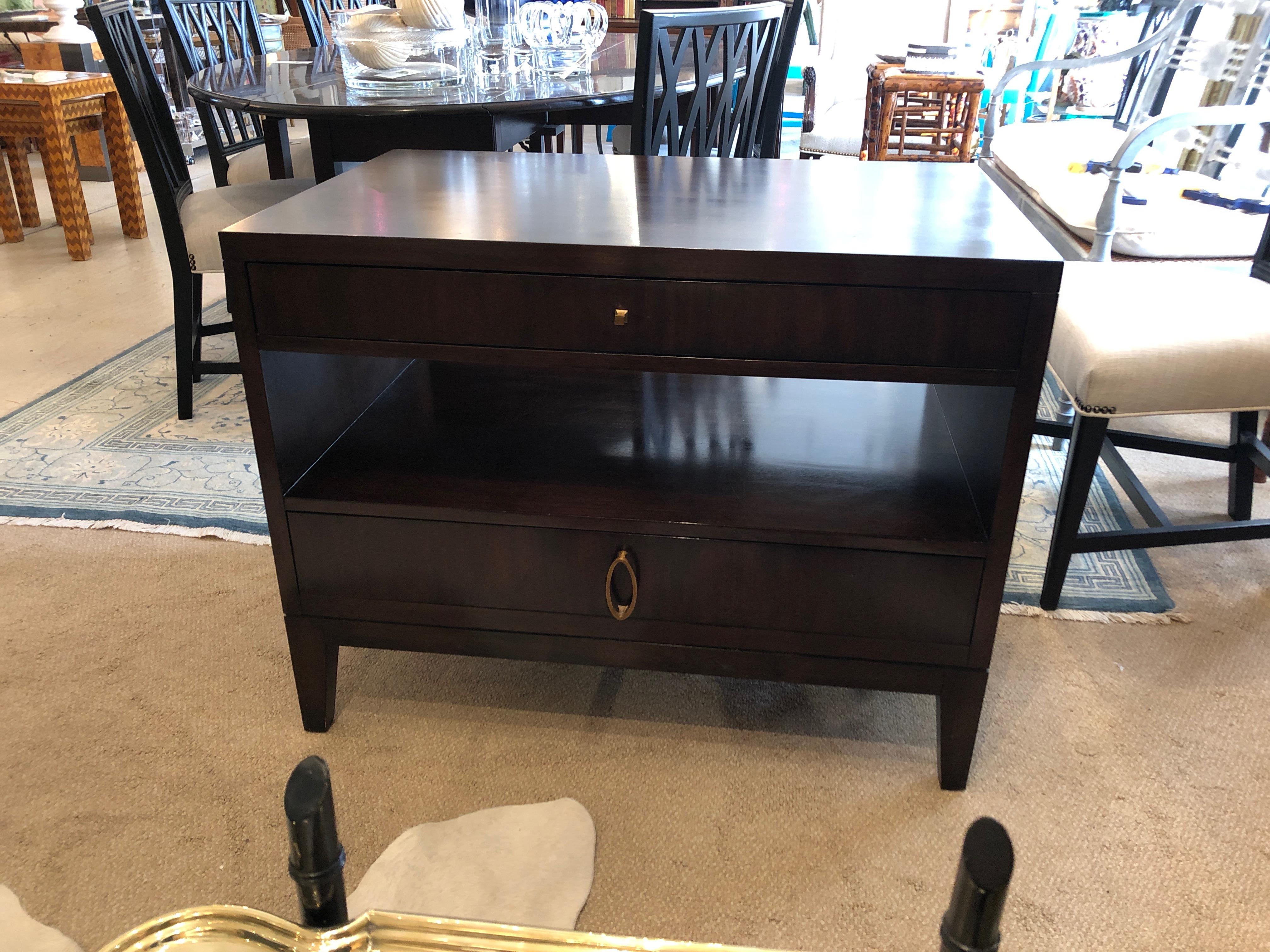 Two well made dark mahogany nightstands by Barbara Barry with her Classic elegance, having a narrow drawer on top, open area in the middle, and larger drawer at the bottom. Tapered handsome feet and modern brass hardware.