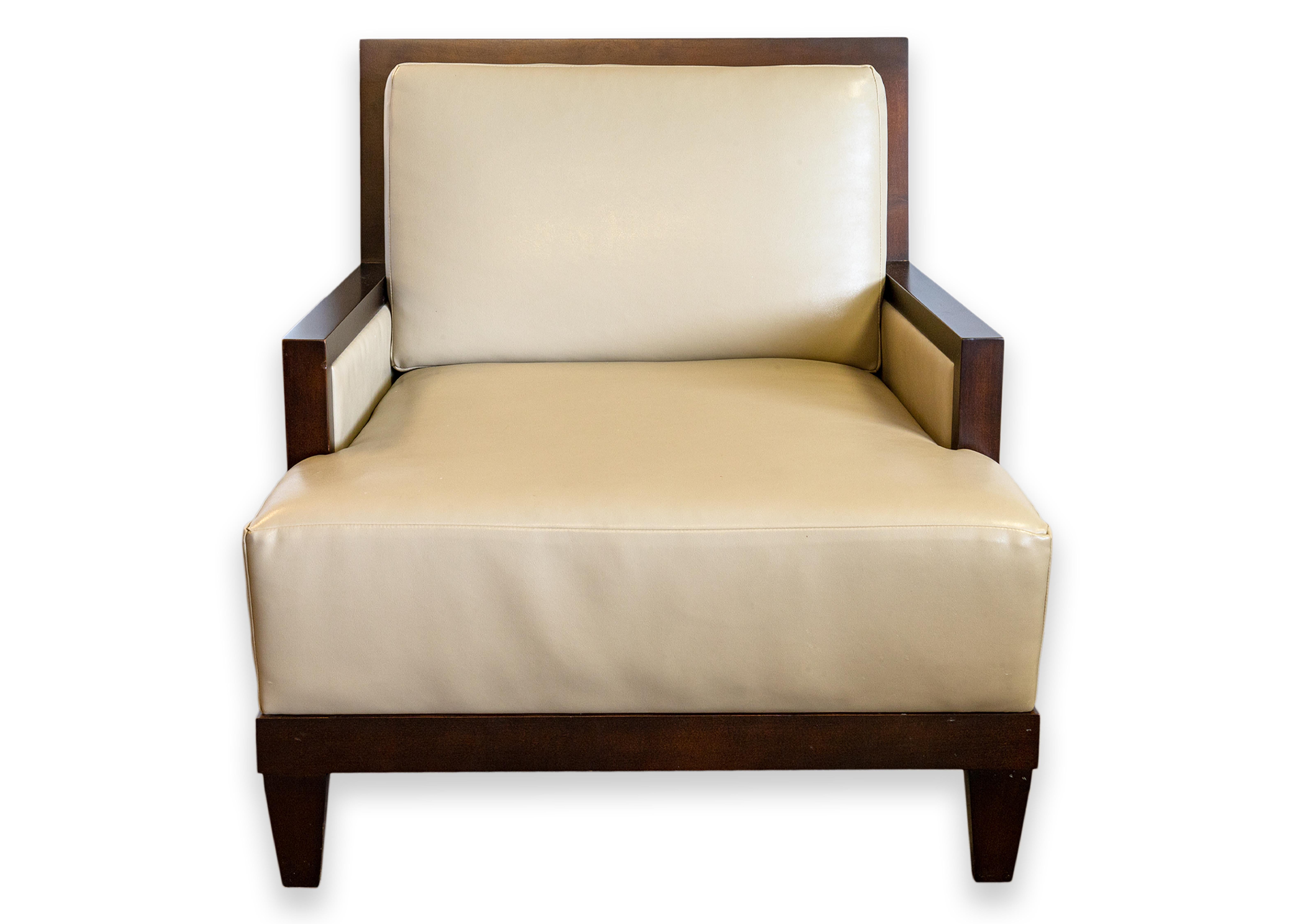 A pair of Barbara Barry for Baker boxback lounge chairs. This set of chairs have a classic modern design. They feature a classic set of materials in leather and wood. The frame is a dark wood with a slightly gloss finish. The leather upholstery is a