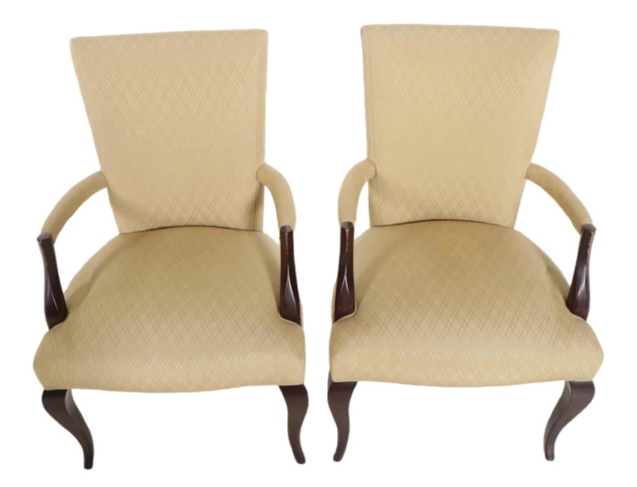 Pair of impressive Art Deco influenced arm chairs by Barbara Barry for Baker Furniture Company. Upholstered in a silk blend cross hatch seat, arm and back. Exposed wood is a very dark brown lacquer over mahogany. Barbara Barry is an iconic figure in