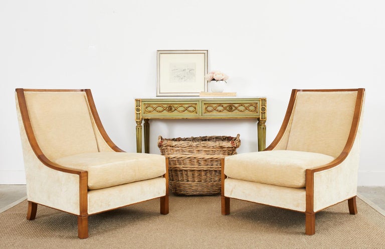 Grand pair of velvet and hardwood lounge chairs or club chairs designed by Barbara Barry for Baker. Made in the art deco style the chairs feature a gracefully curved back and sides giving the gondola style chairs a dramatic profile. The frames are