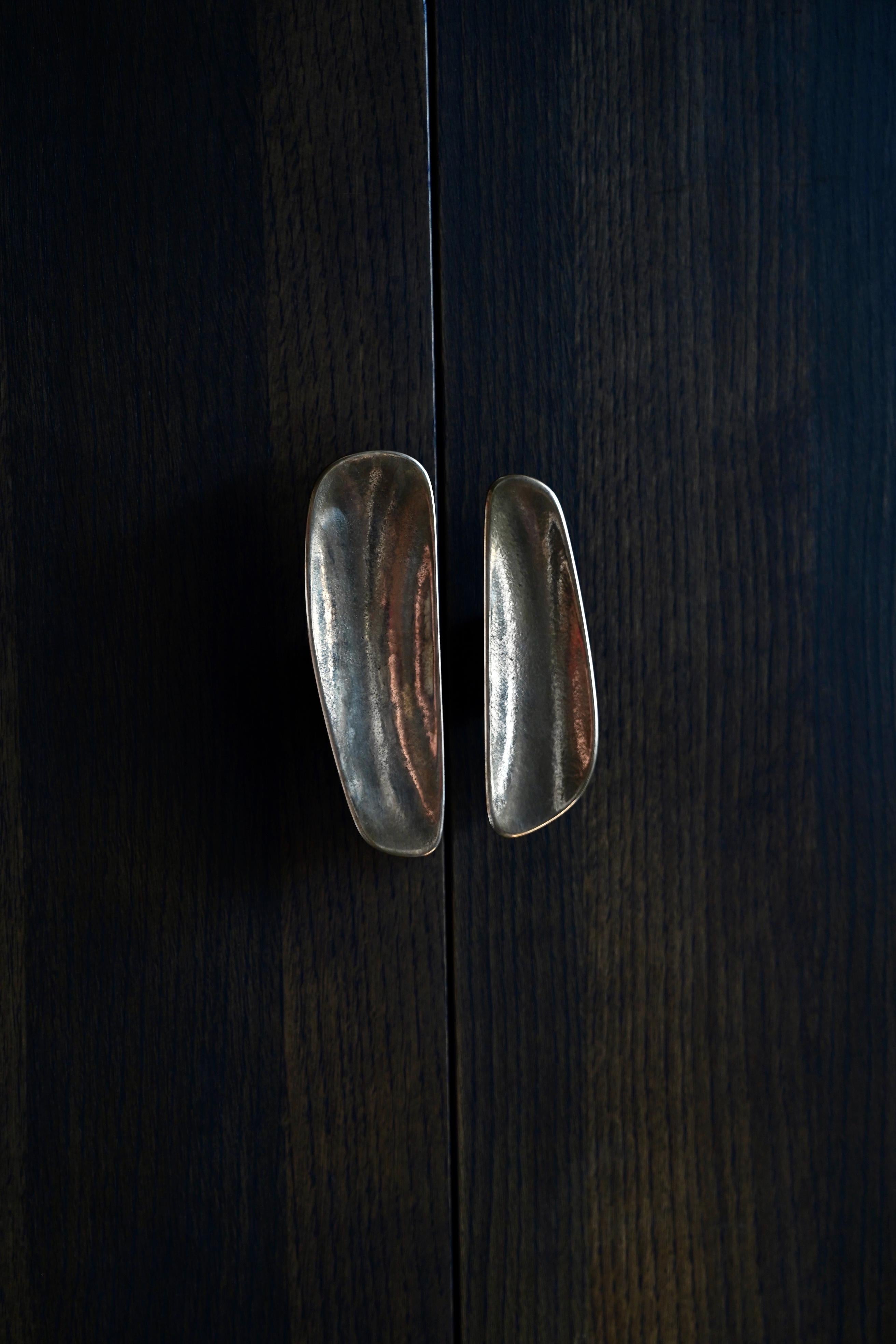 This asymmetrical PAIR of Fermat Cabinet Handles are cast from solid bronze. 

The Fermat range provides a tactile and beautiful addition to interior spaces.   Designed to be applied to cabinets and internal doors,  these soft forms are a pleasure