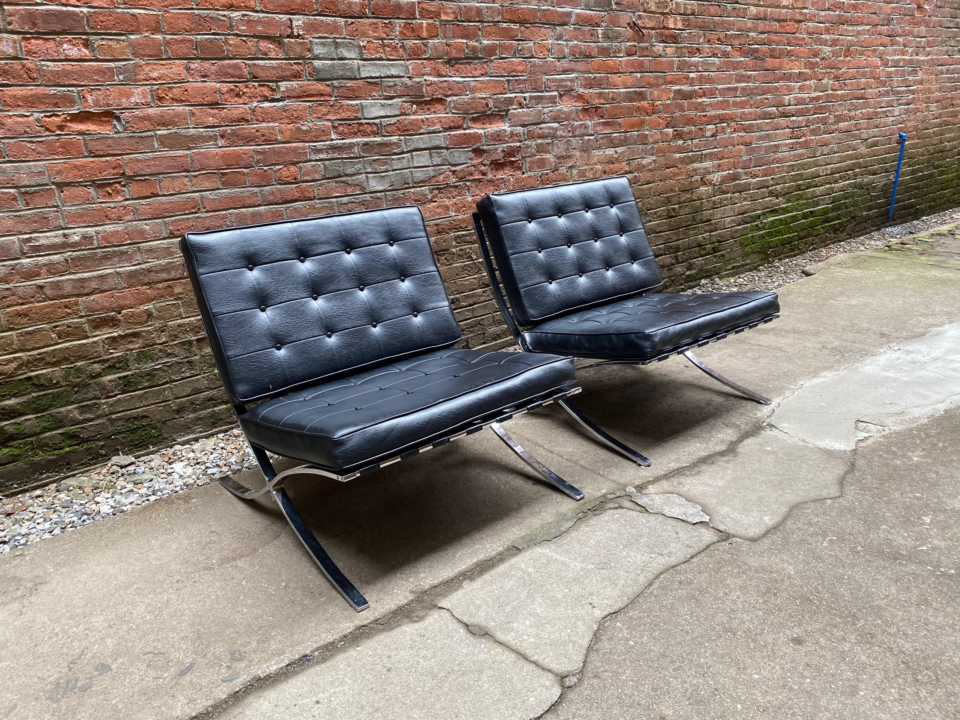 A fine pair of Barcelona style lounge chairs for Chris Boyce Associates, Orange, California. Chrome-plated flat bar steel chairs with the original tufted black vinyl cushions, circa 1970-1980. Very clean and good condition. Still bares the original